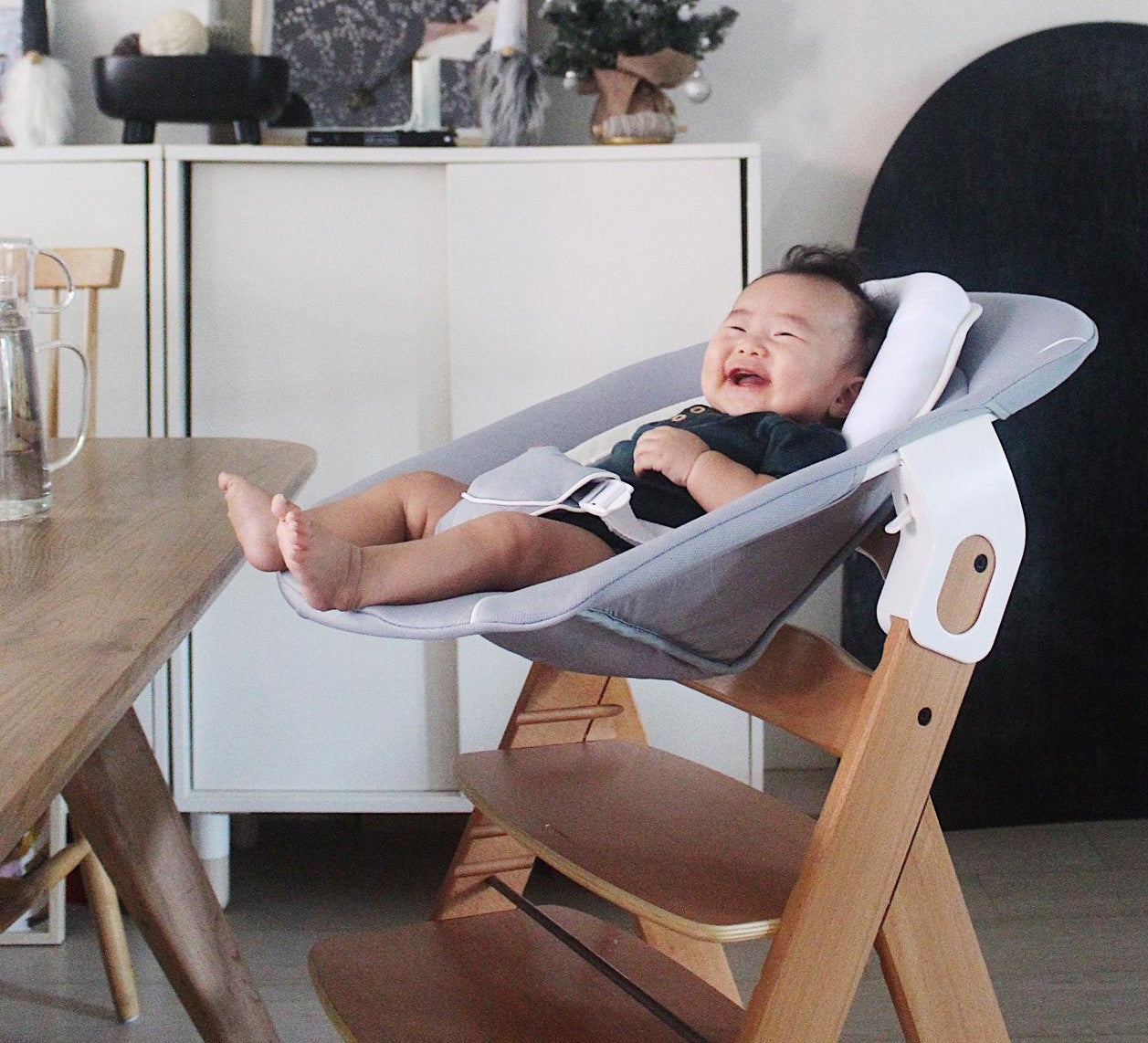 baby boy lying in high chair