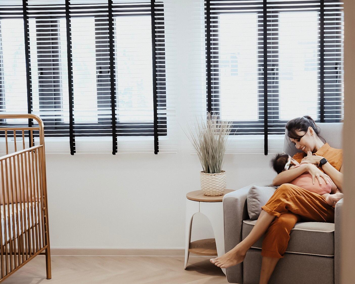 mum carrying baby on piper recliner nursing chair