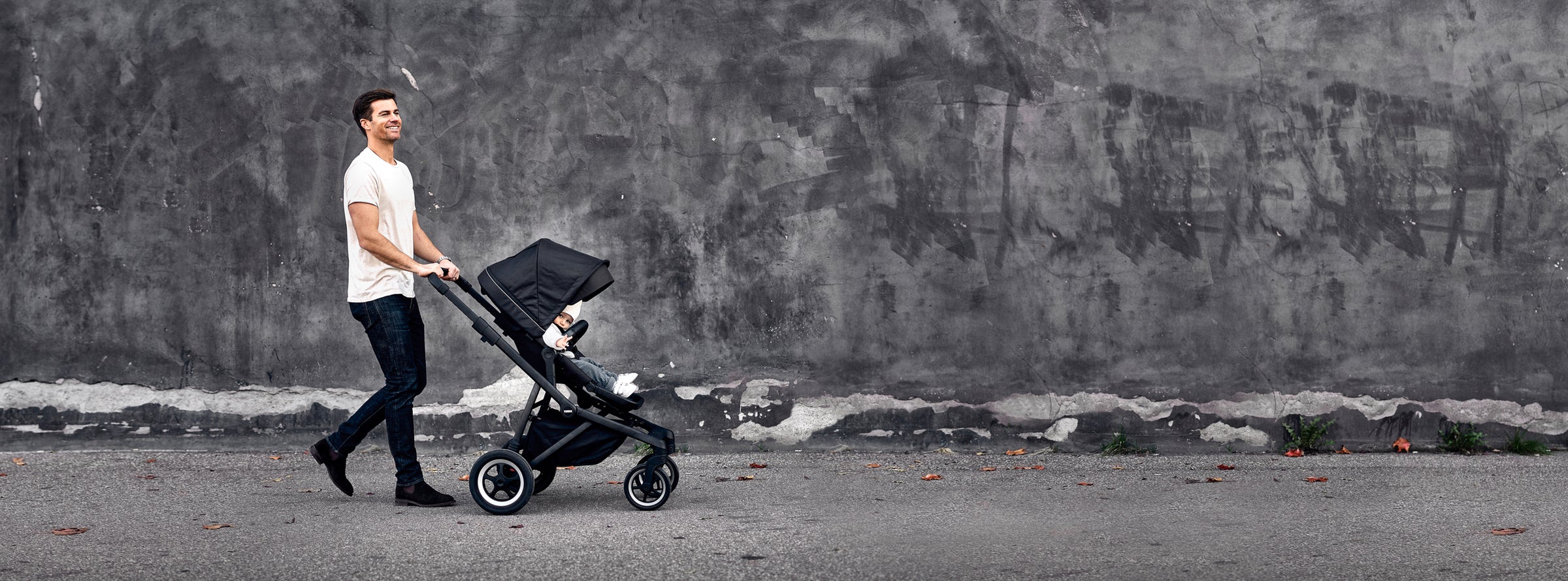 dad pushing child in all terrain stroller