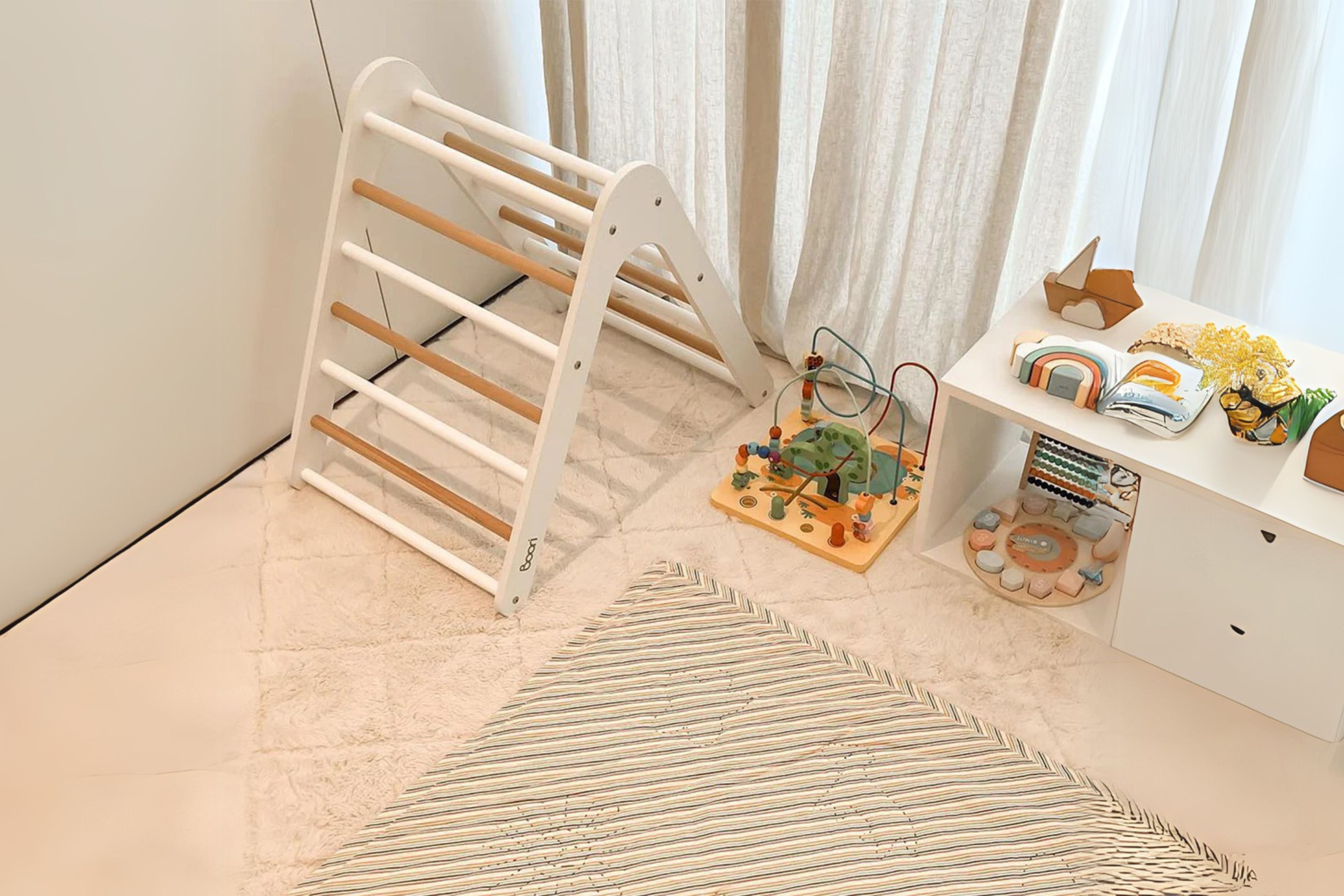 Boori Tidy Climbing Frame Climbing Pikler Triangle in a corner of a cosy toy filled nursery room