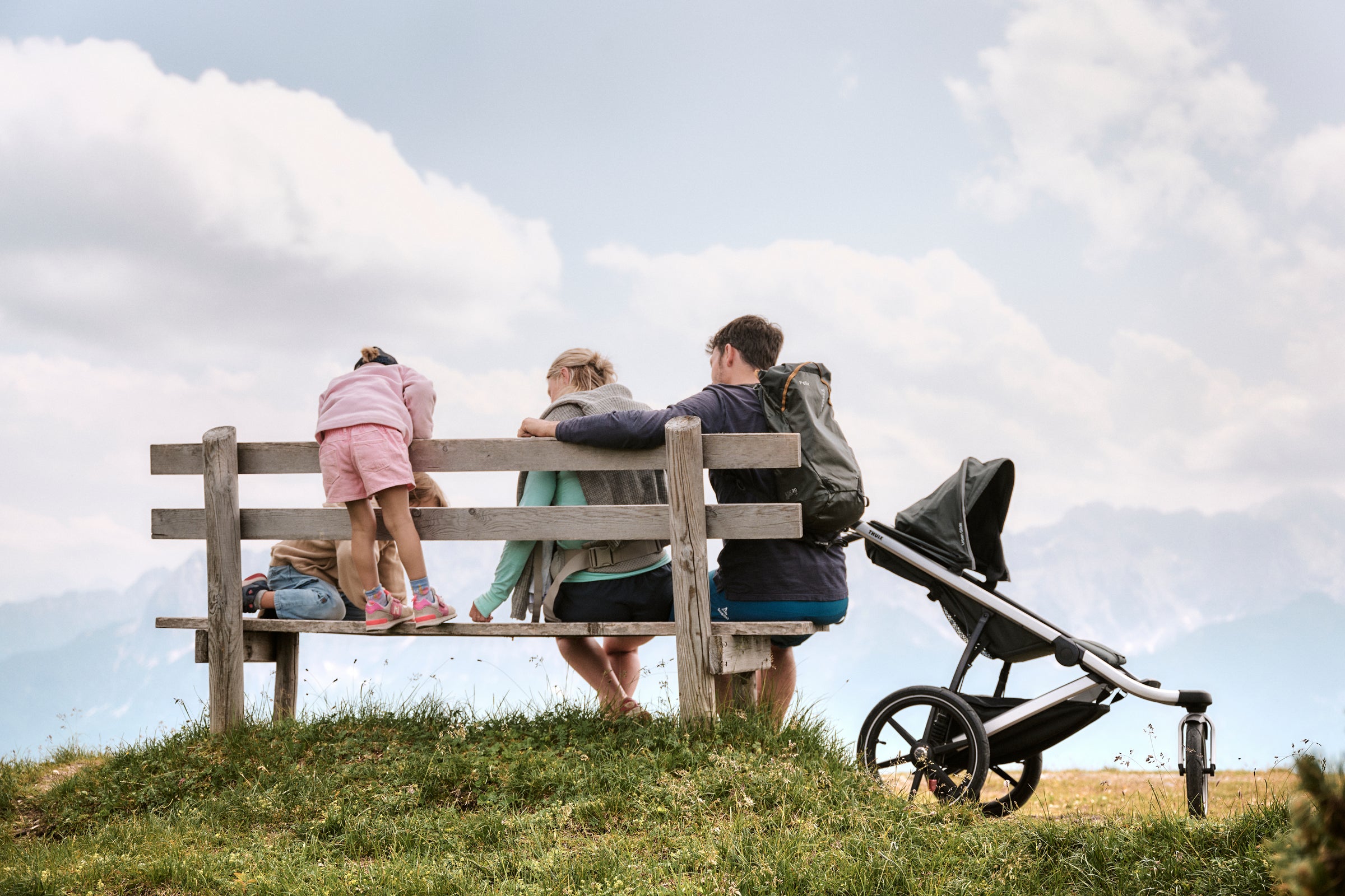 Family hiking and enjoying the nature and outdoor nature with Thule stroller