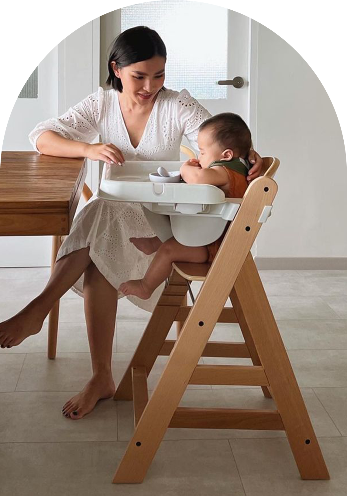 mother and baby at the dining table with child in alpha high chair with tray