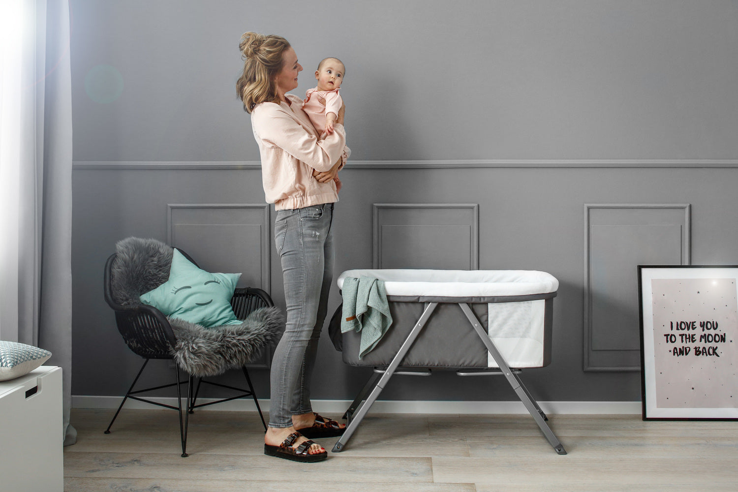 mom with baby and hauck bedside cot
