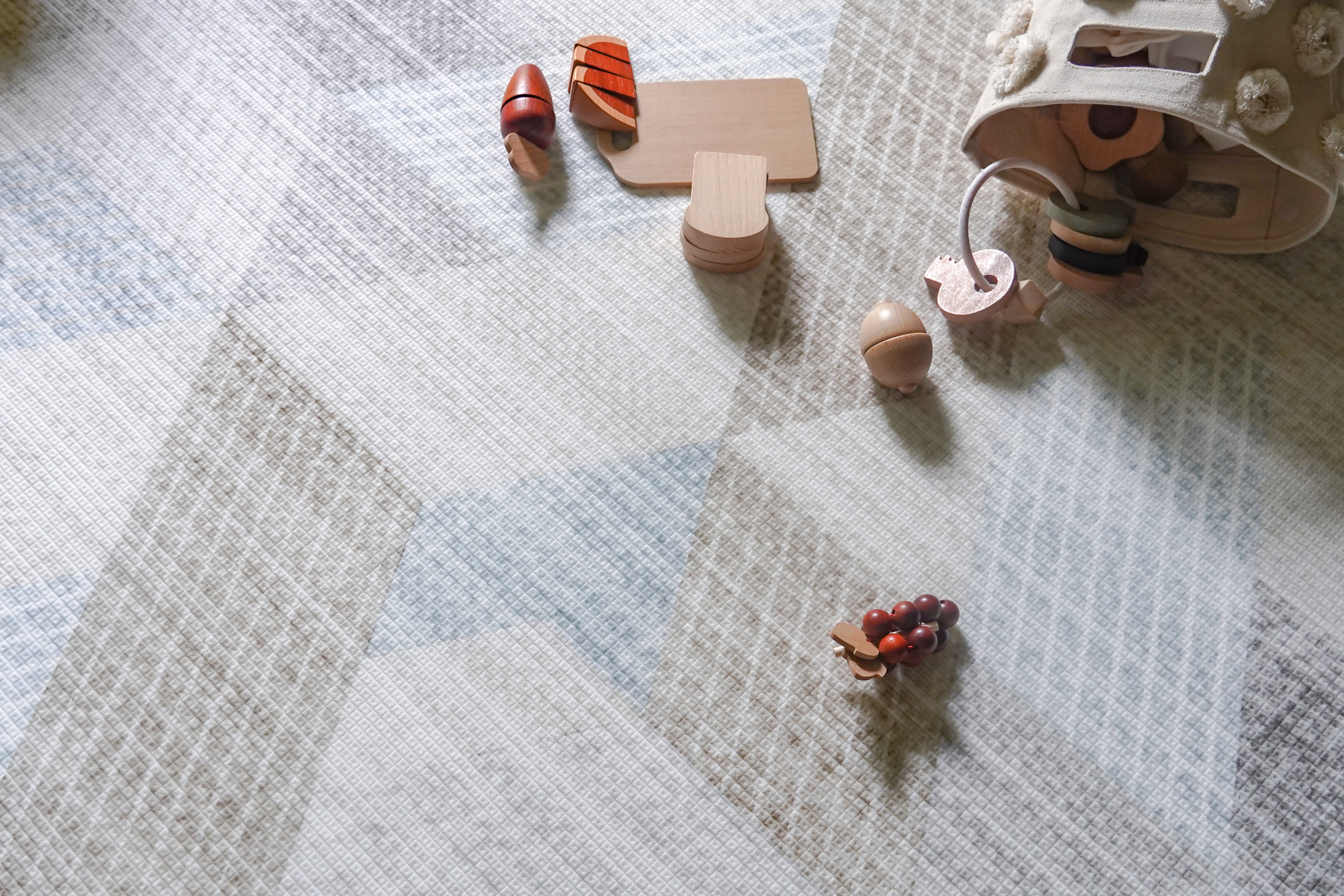 wooden toy blocks on lollibly snow dune play mat