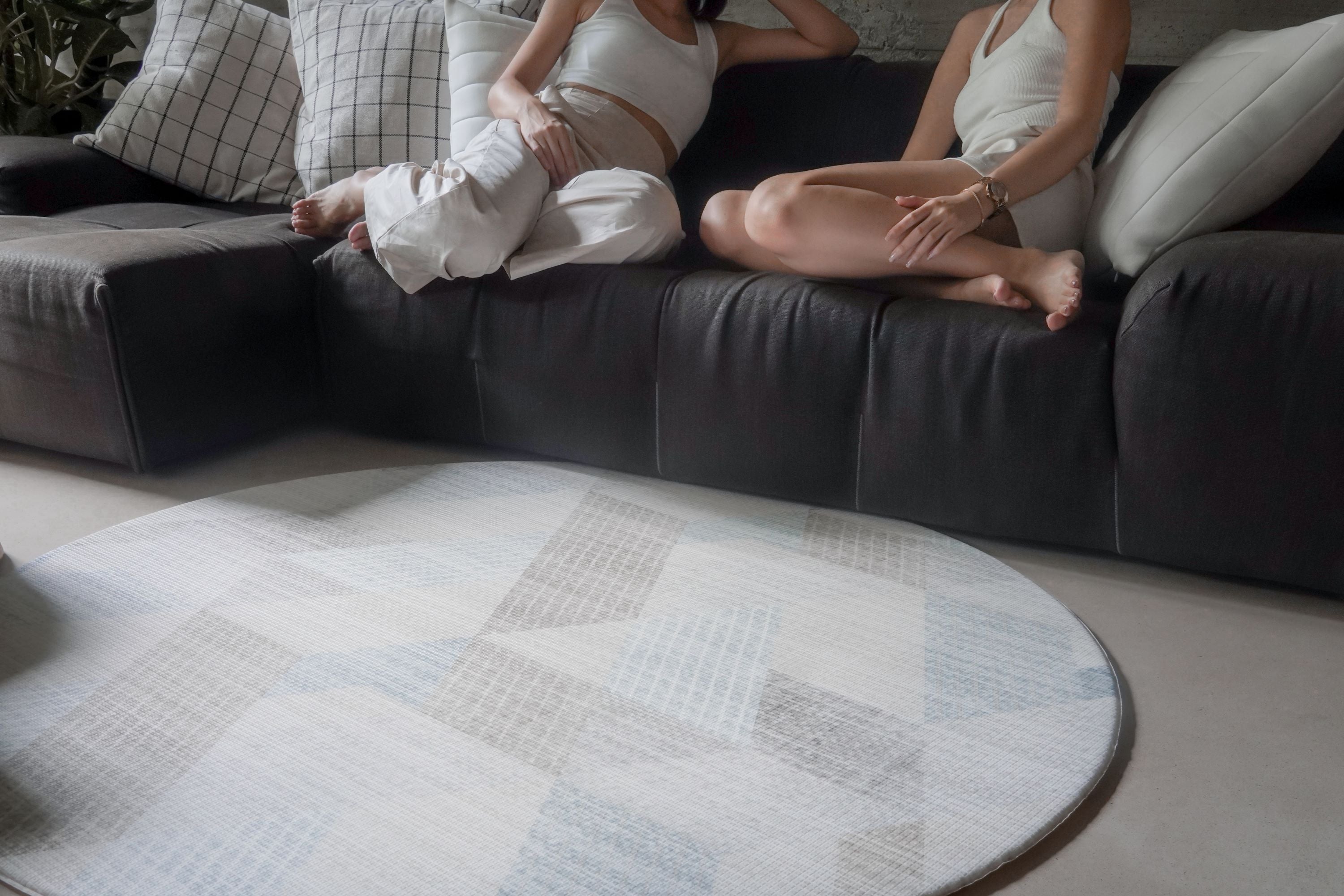 ladies sitting on the couch with lollibly round snow dune play mat