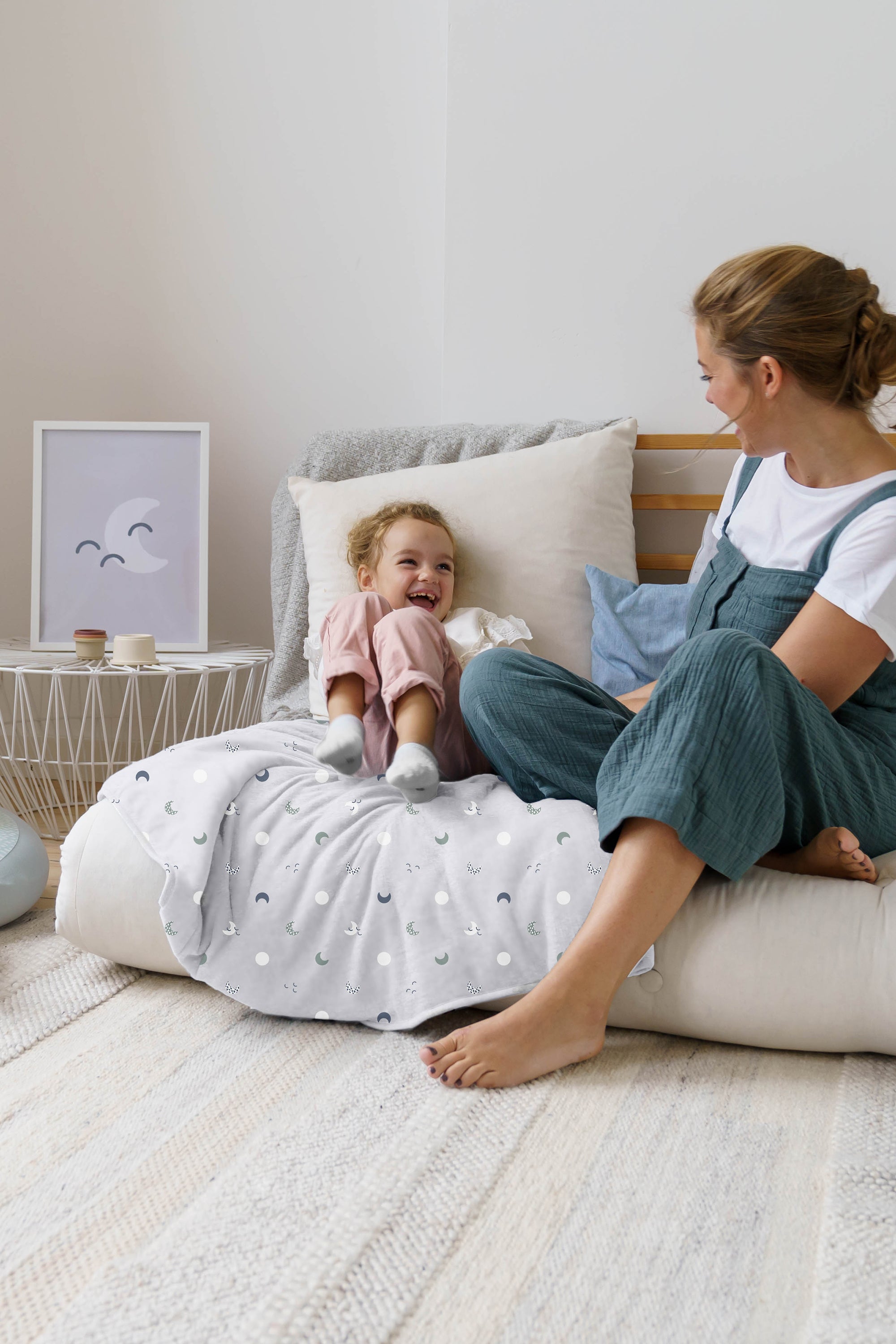 laughing toddler sitting on doomoo dream blanket blue grey#color_blue-grey-moon
