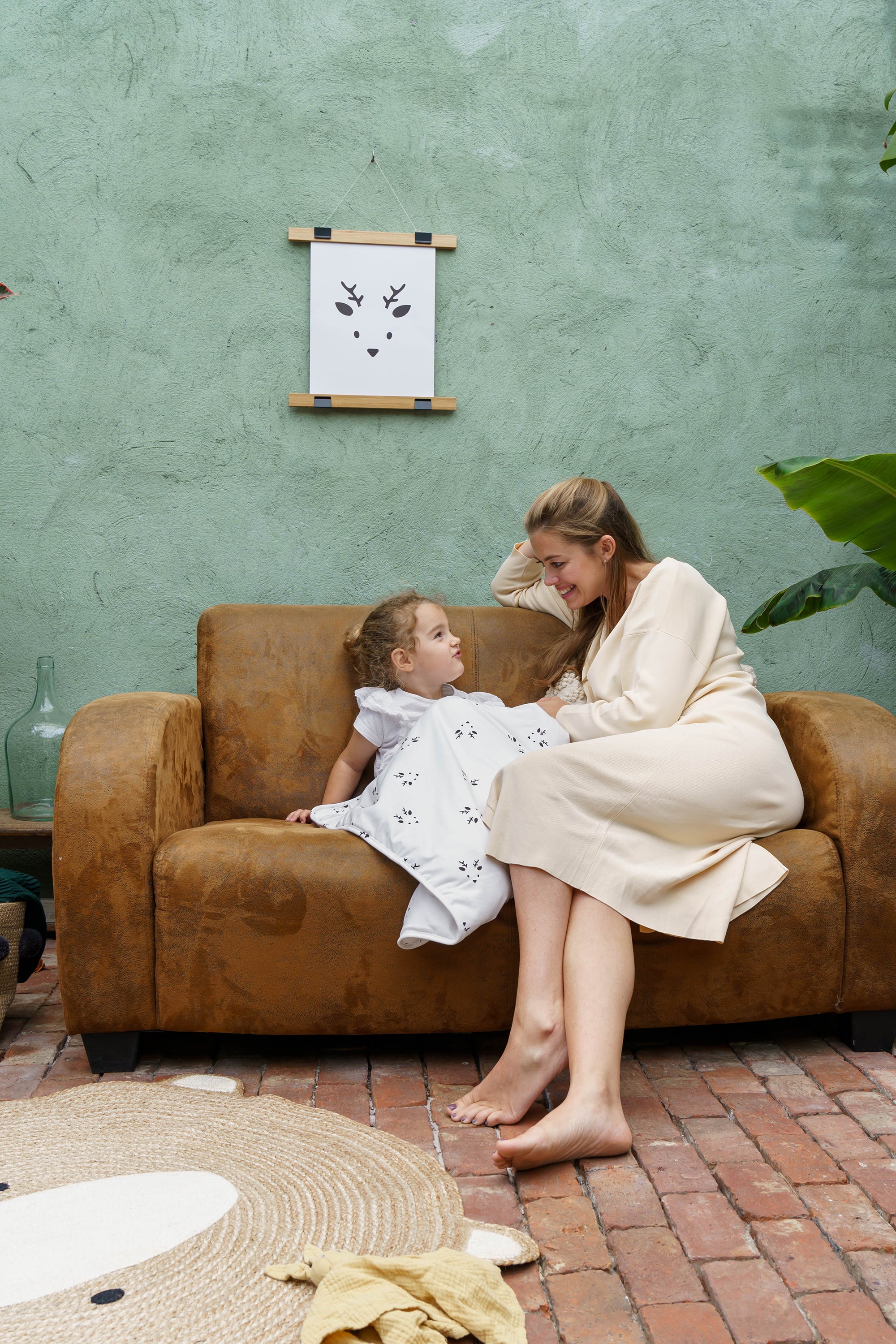 toddler with mom on couch and doomoo dream deer blanket#color_deer