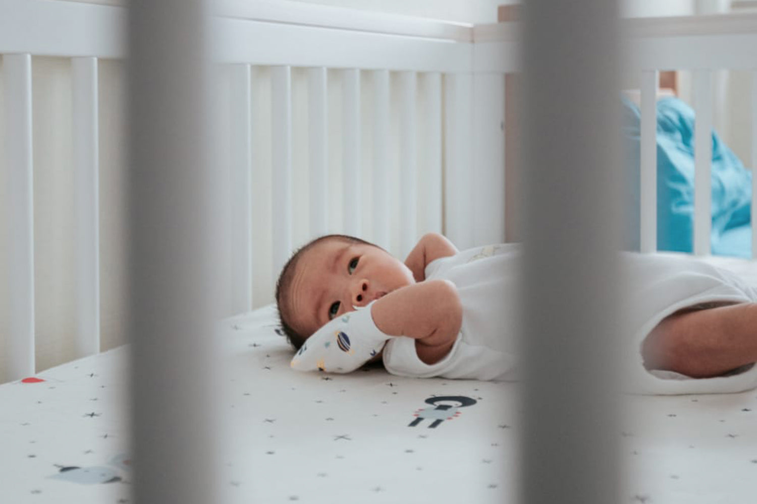 baby falling asleep in a safe baby crib