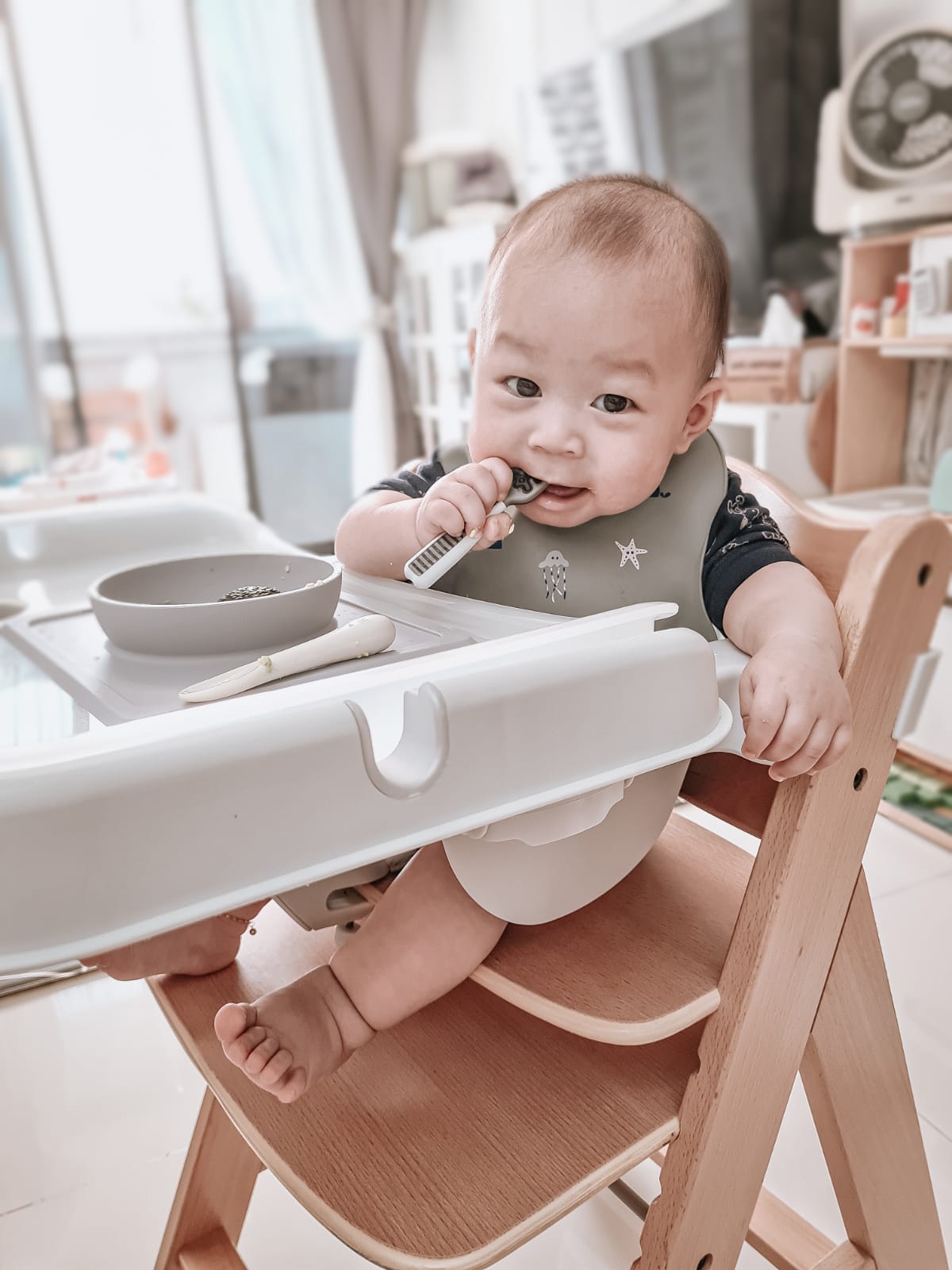 baby sitting on alpha hauck high chair having solid food happy baby led weaning