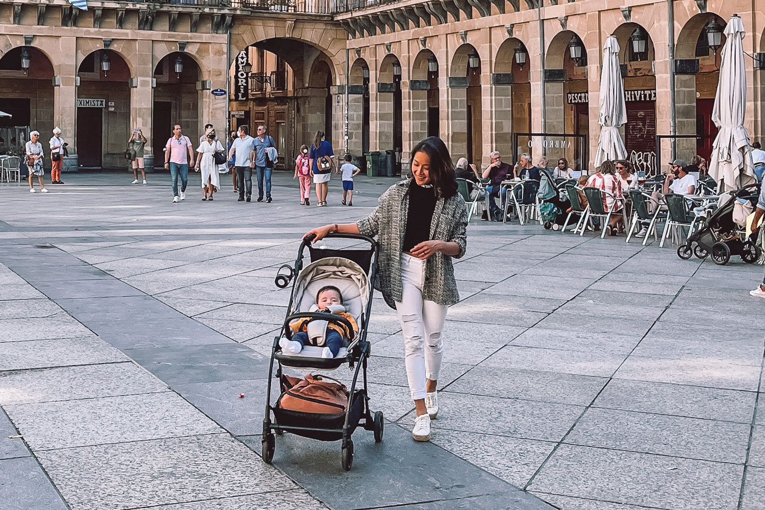 mum pushing newborn baby stroller in europe