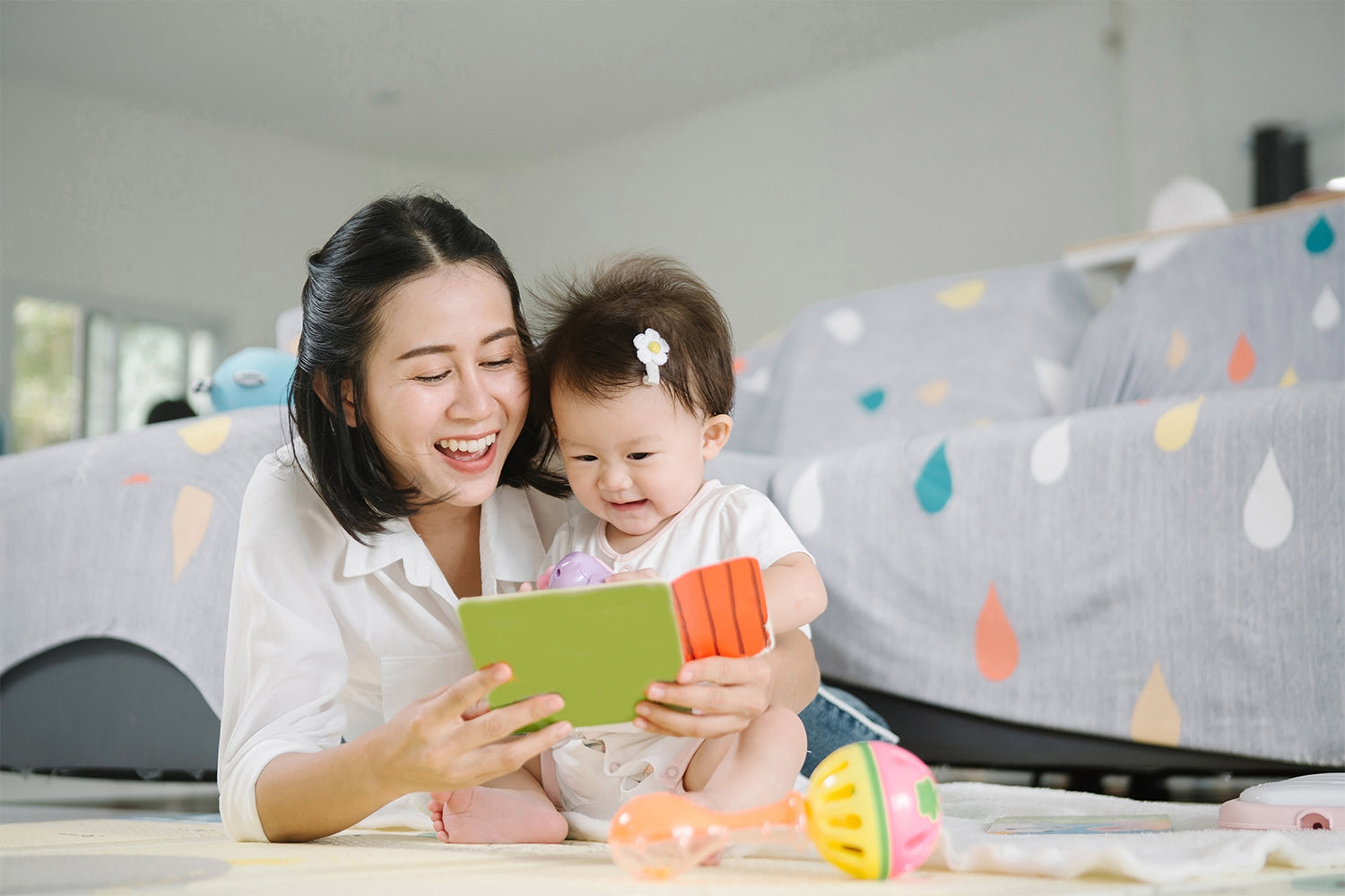 mother and child having fun while reading a book together