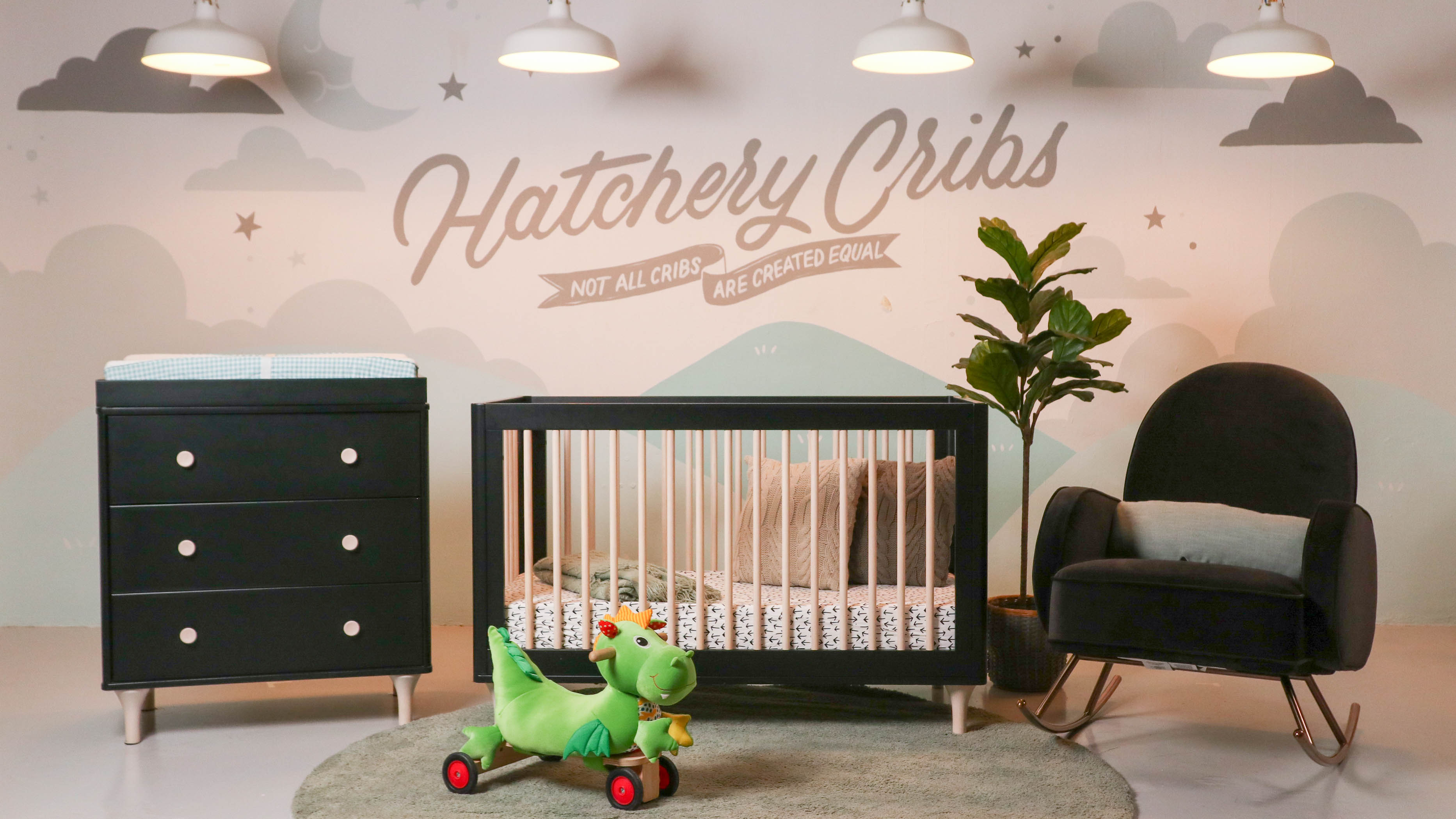 Baby crib, changing table and nursing chair in baby furniture store showroom