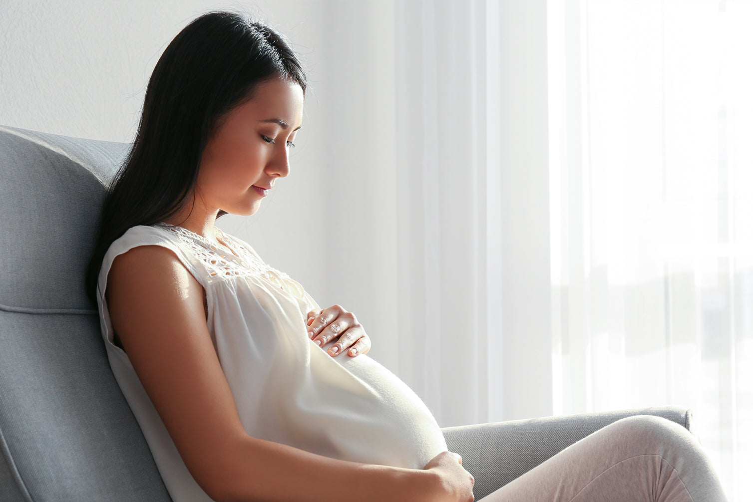 pregnant woman sitting in living room