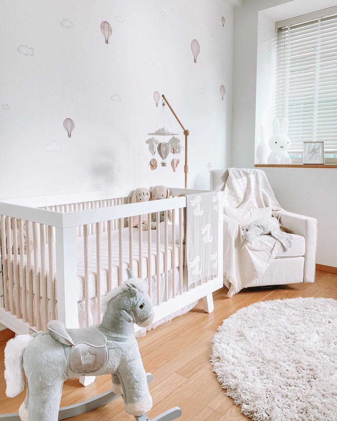 Baby nursery room with crib and nursing chair