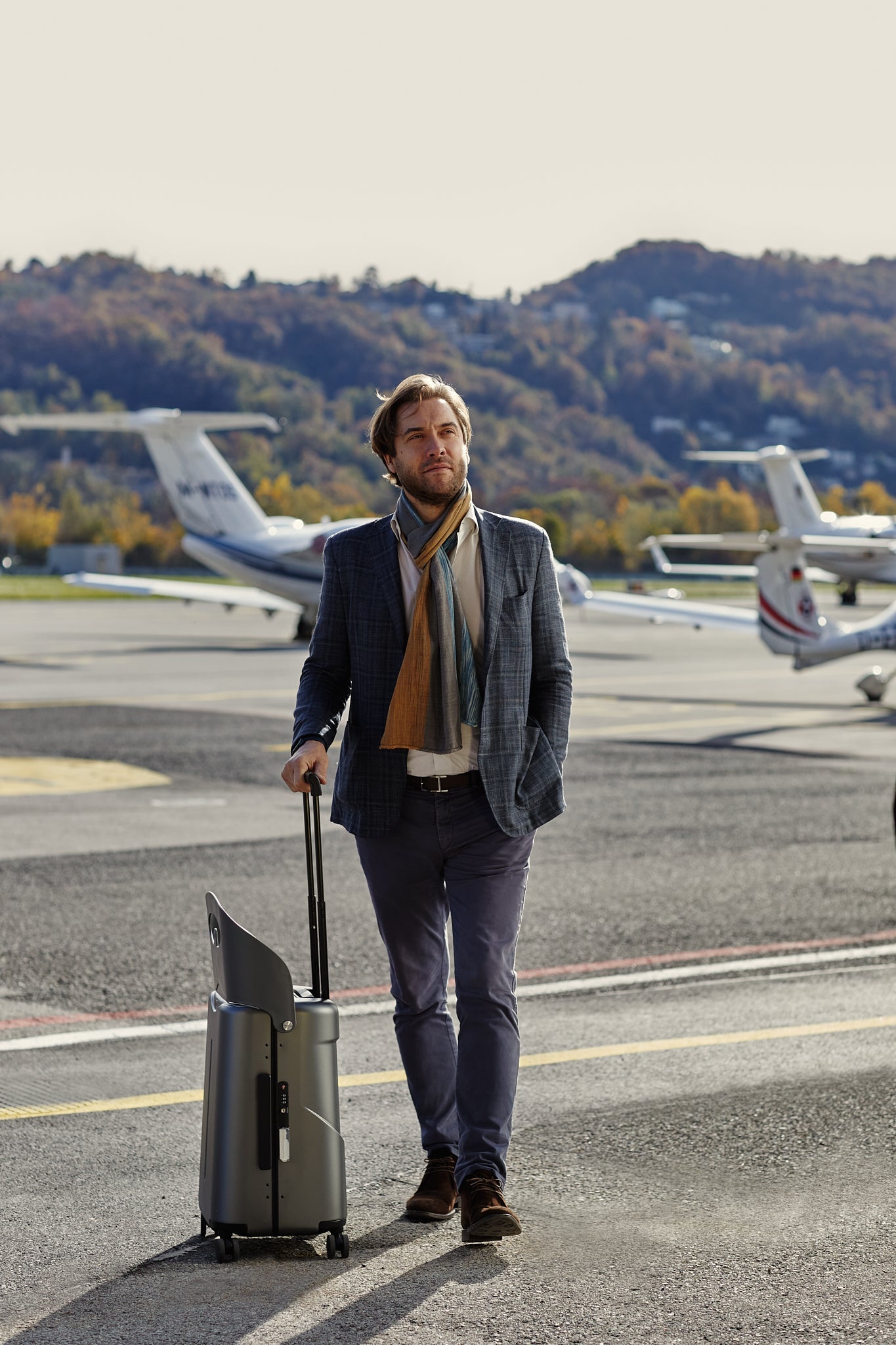 man with miamily charcoal luggage