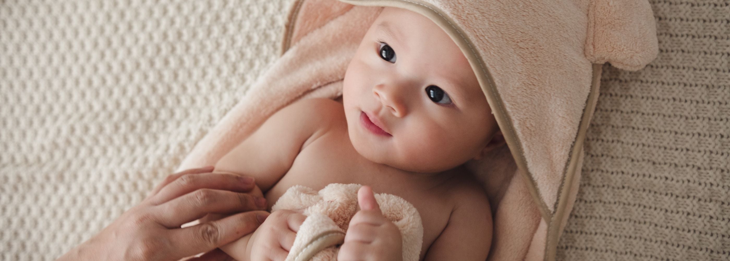 baby in hooded bath towel