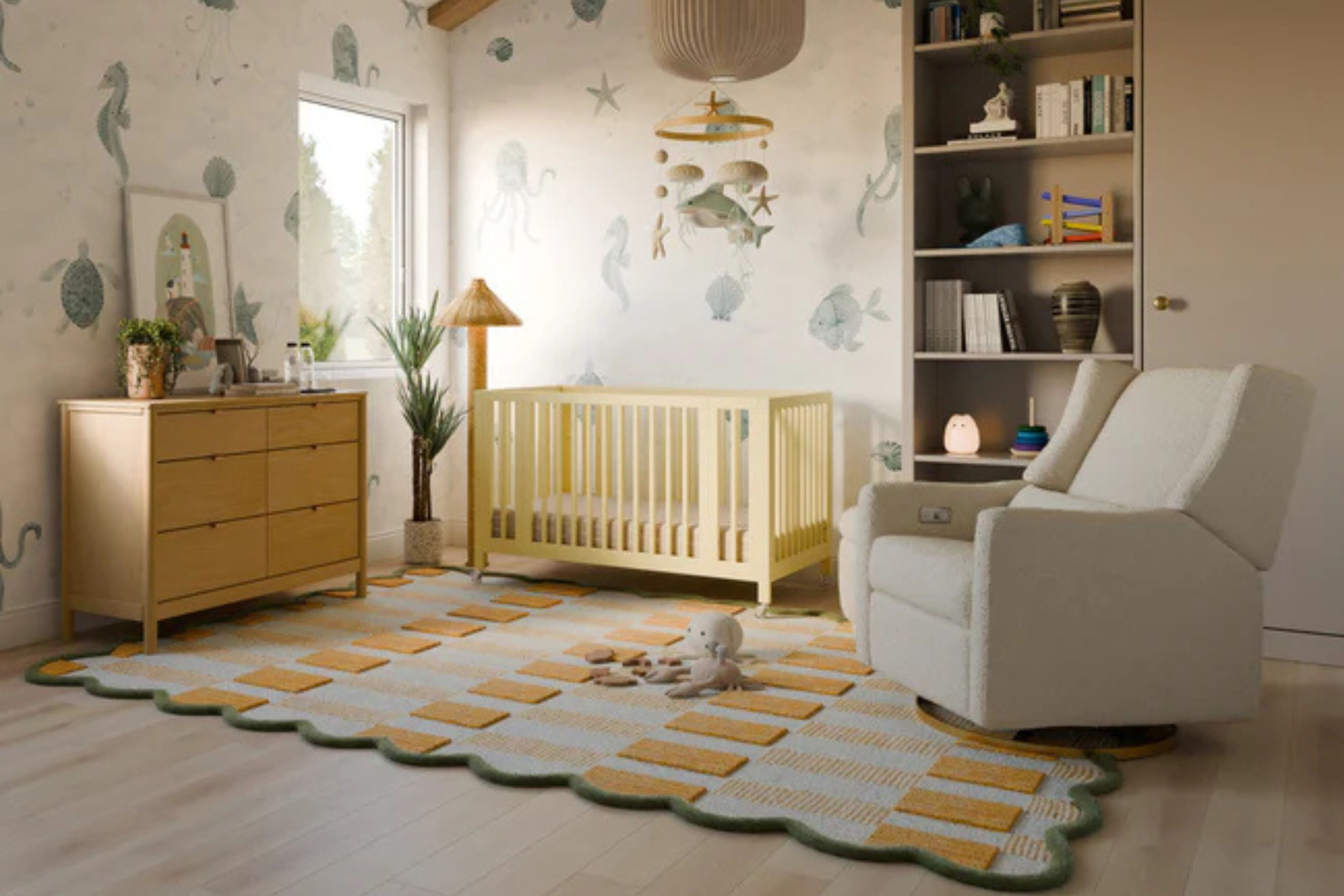 Nursery room with crib, Babyletto Bondi 6-Drawer Assembled Dresser, nursing chair, featuring decorative elements and a rug #color_honey