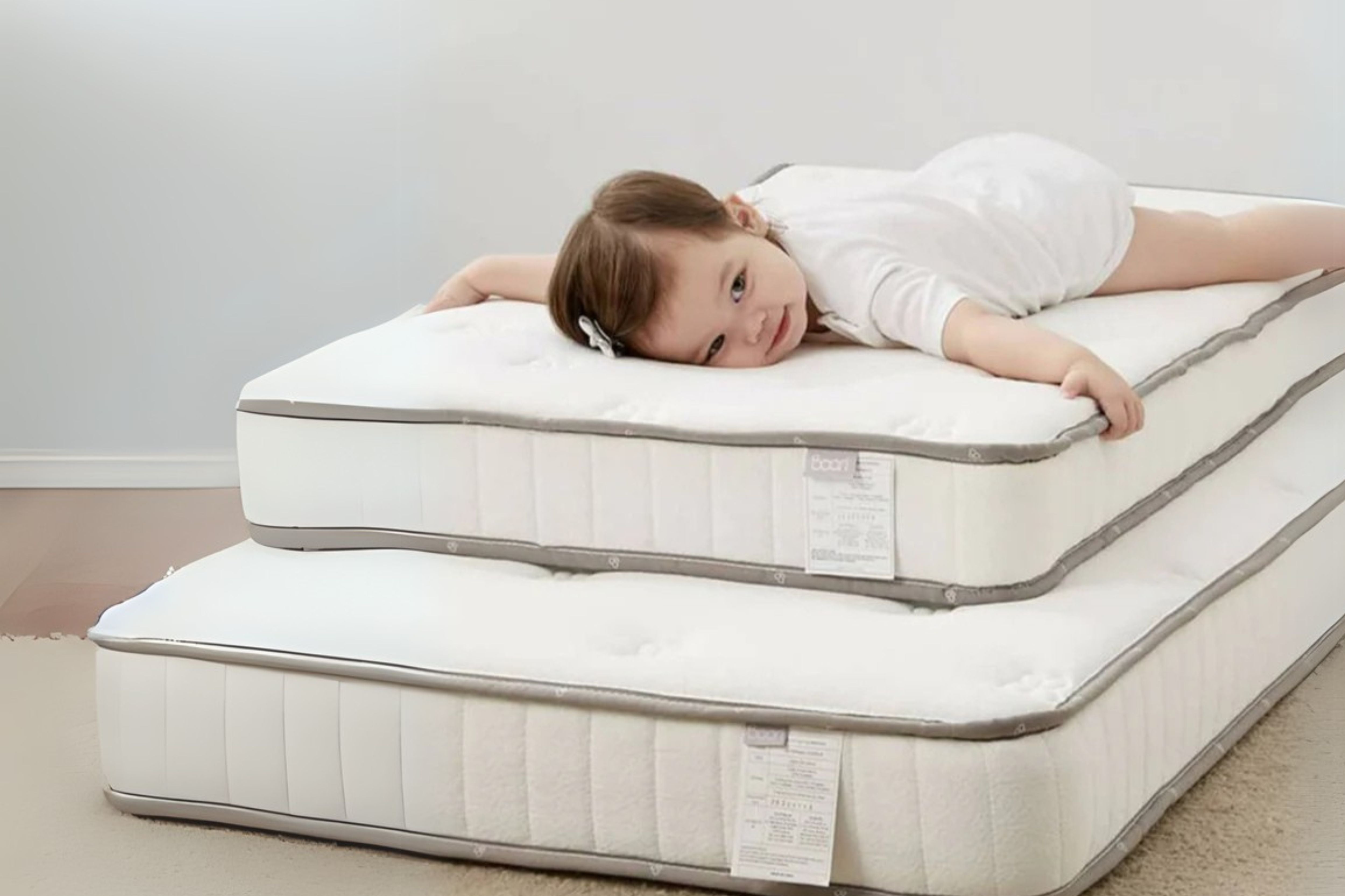 Toddler lying comfortably on two stacked Boori Spring Mattresses of different sizes