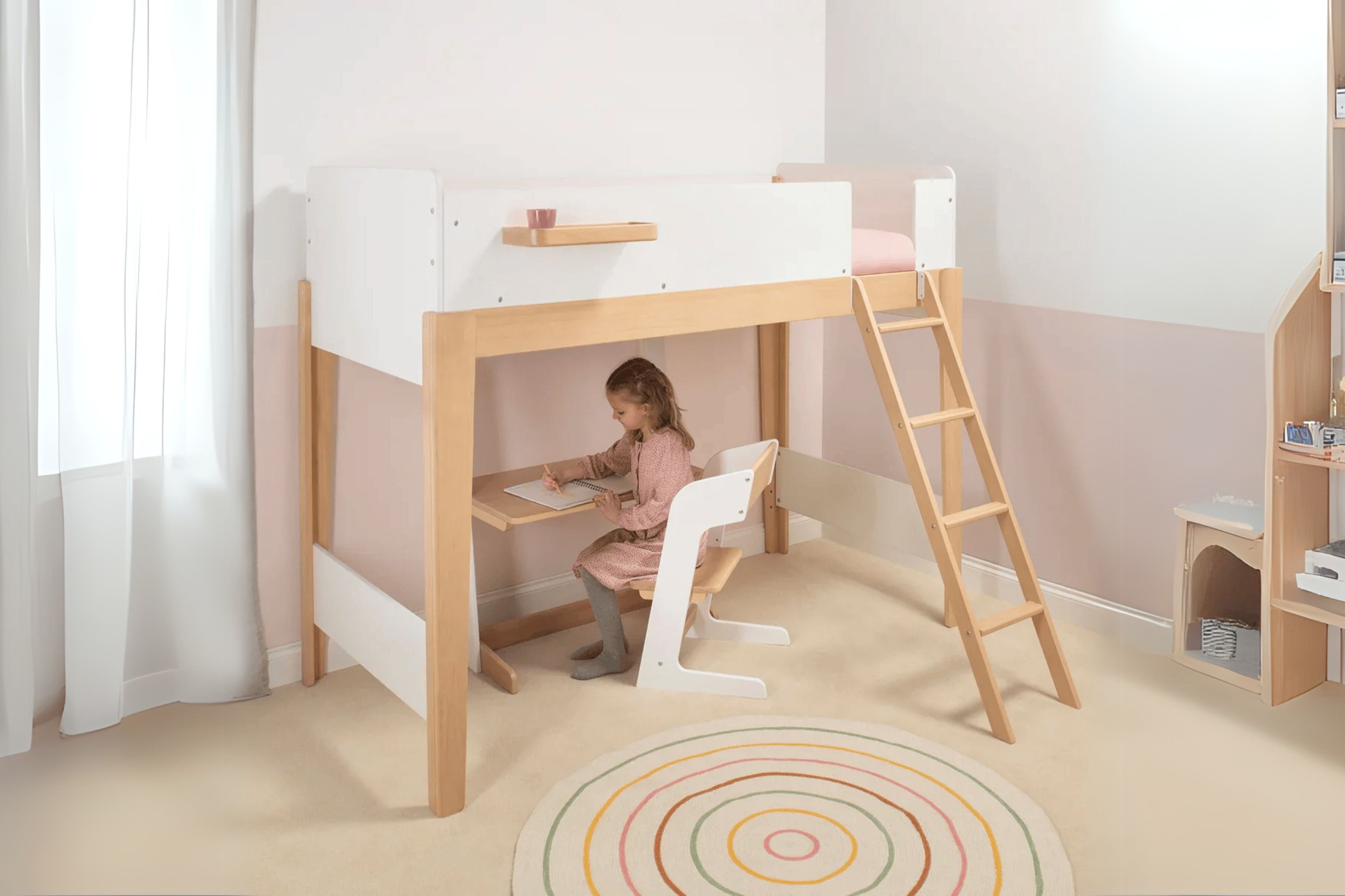 Child using the Boori Natty Single Loft Bed, with a desk setup underneath in a cozy nursery setting
