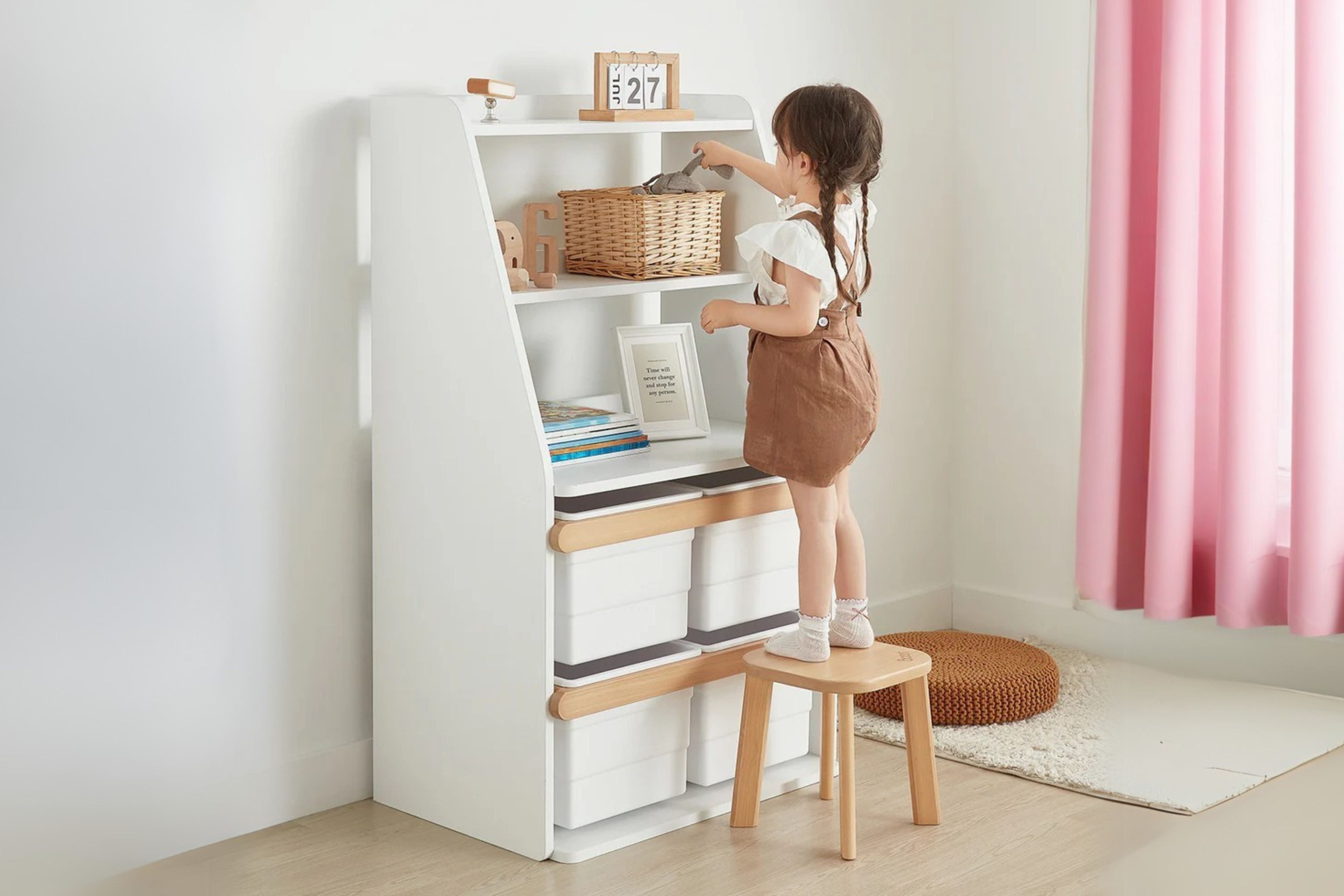 Child retrieving toys from a basket on the shelves of the Boori Tidy Integrated Storage Unit, placed in the corner of a cosy room