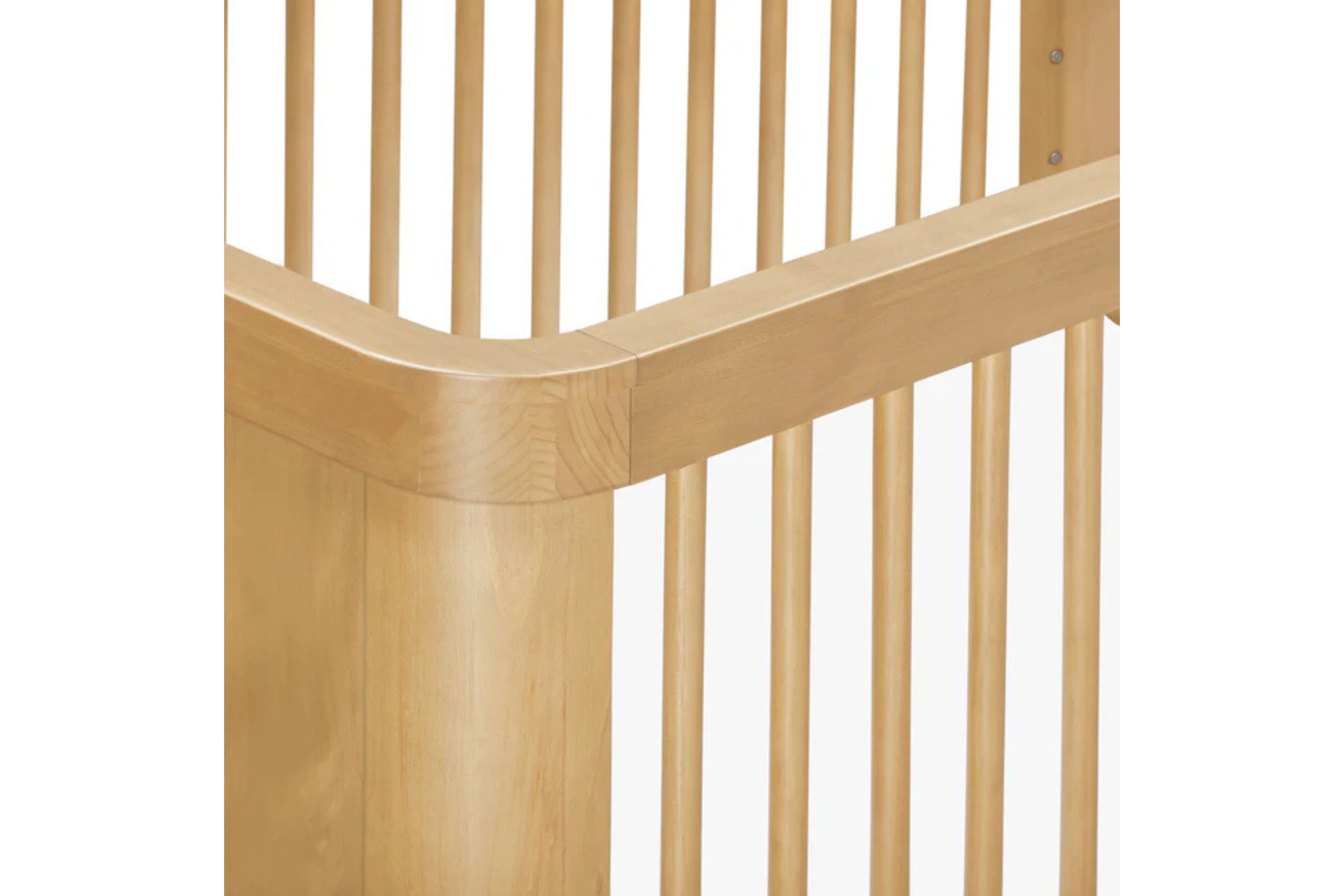 Close-up view of the Babyletto Crosby 3-in-1 Convertible Crib in Honey finish #color_honey