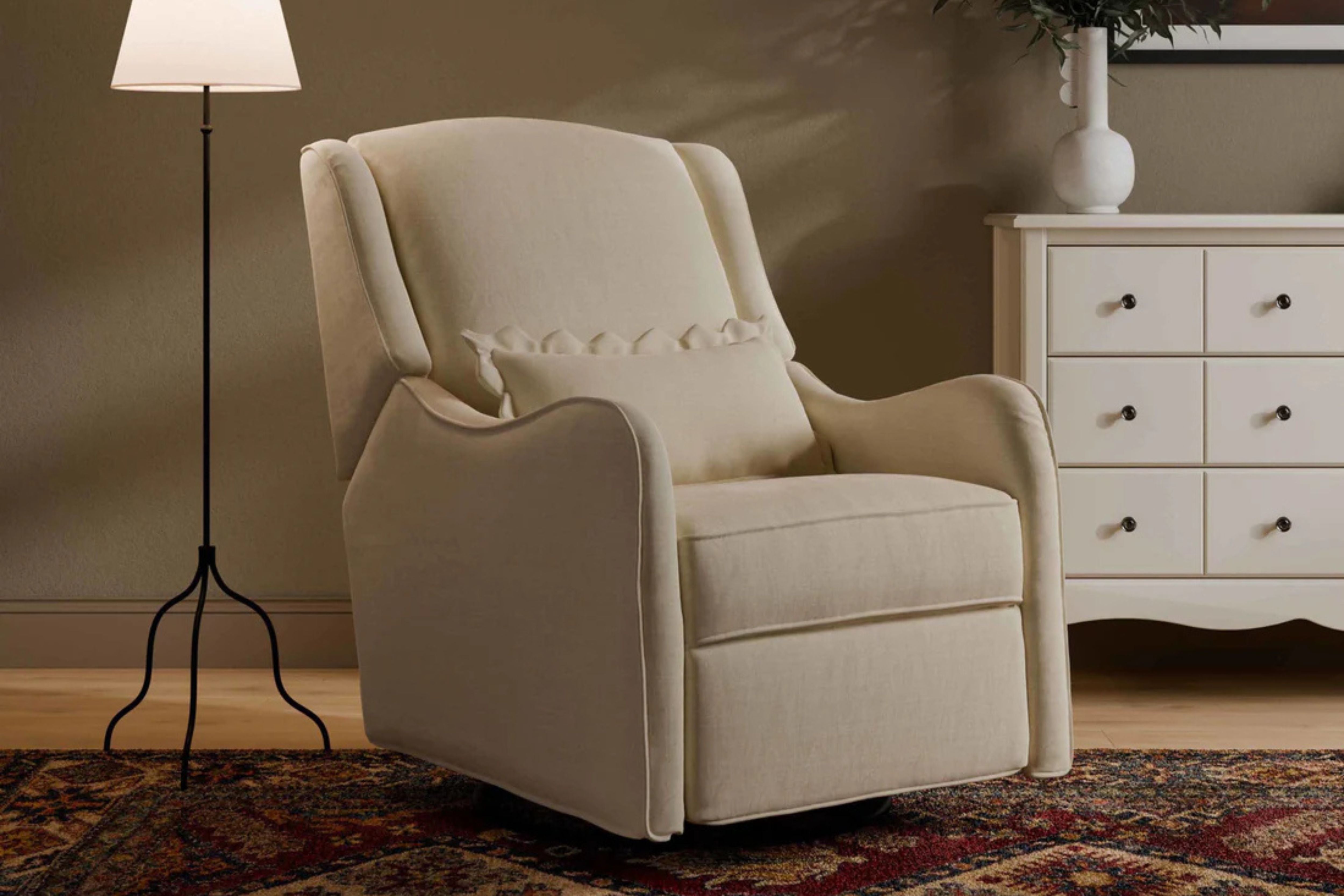 Devon Recliner and Swivel Glider Nursing Chair in Truffle styled in a cozy corner of the nursery #color_cream