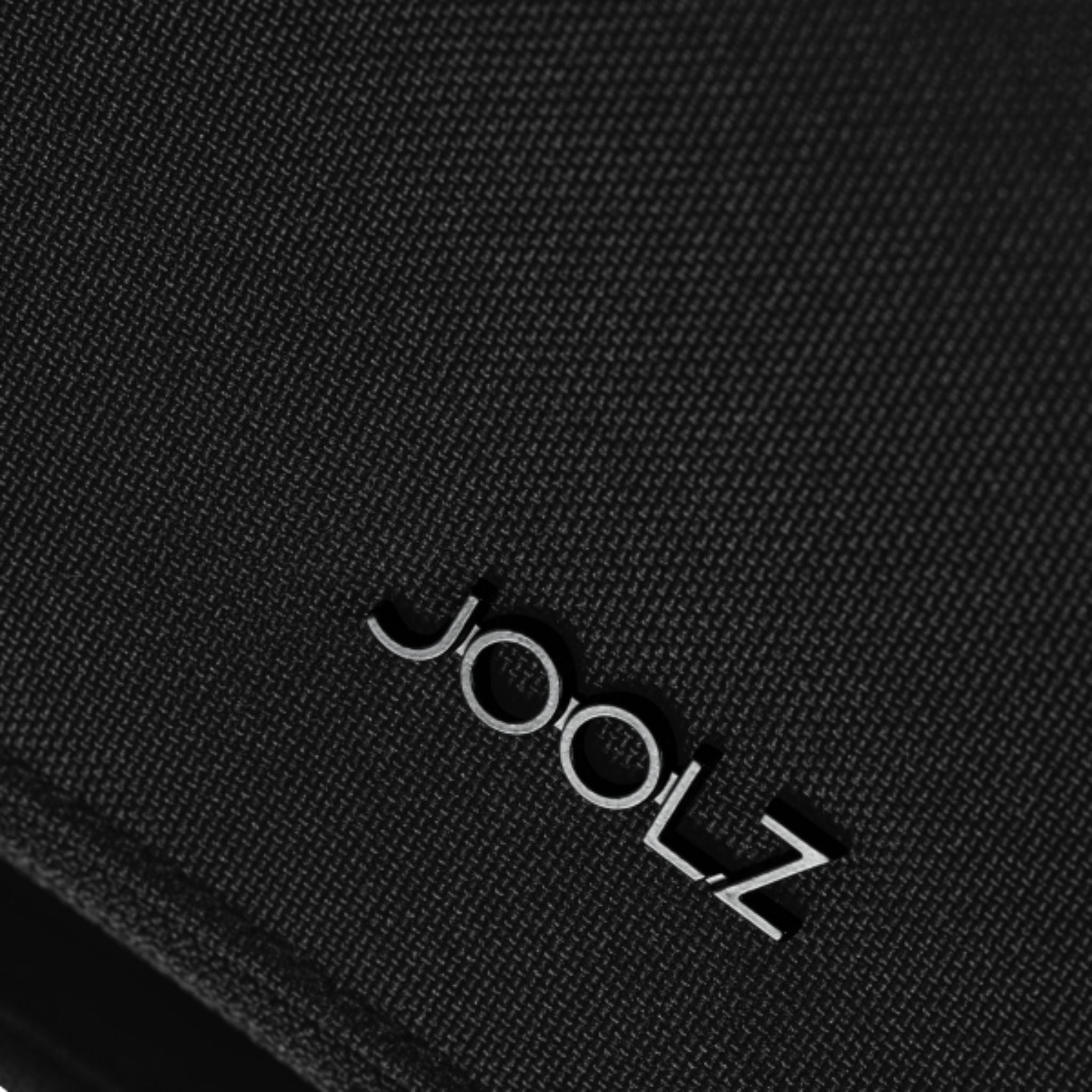 Close-up of a black textured fabric surface with the JOOLZ logo #color_space-black