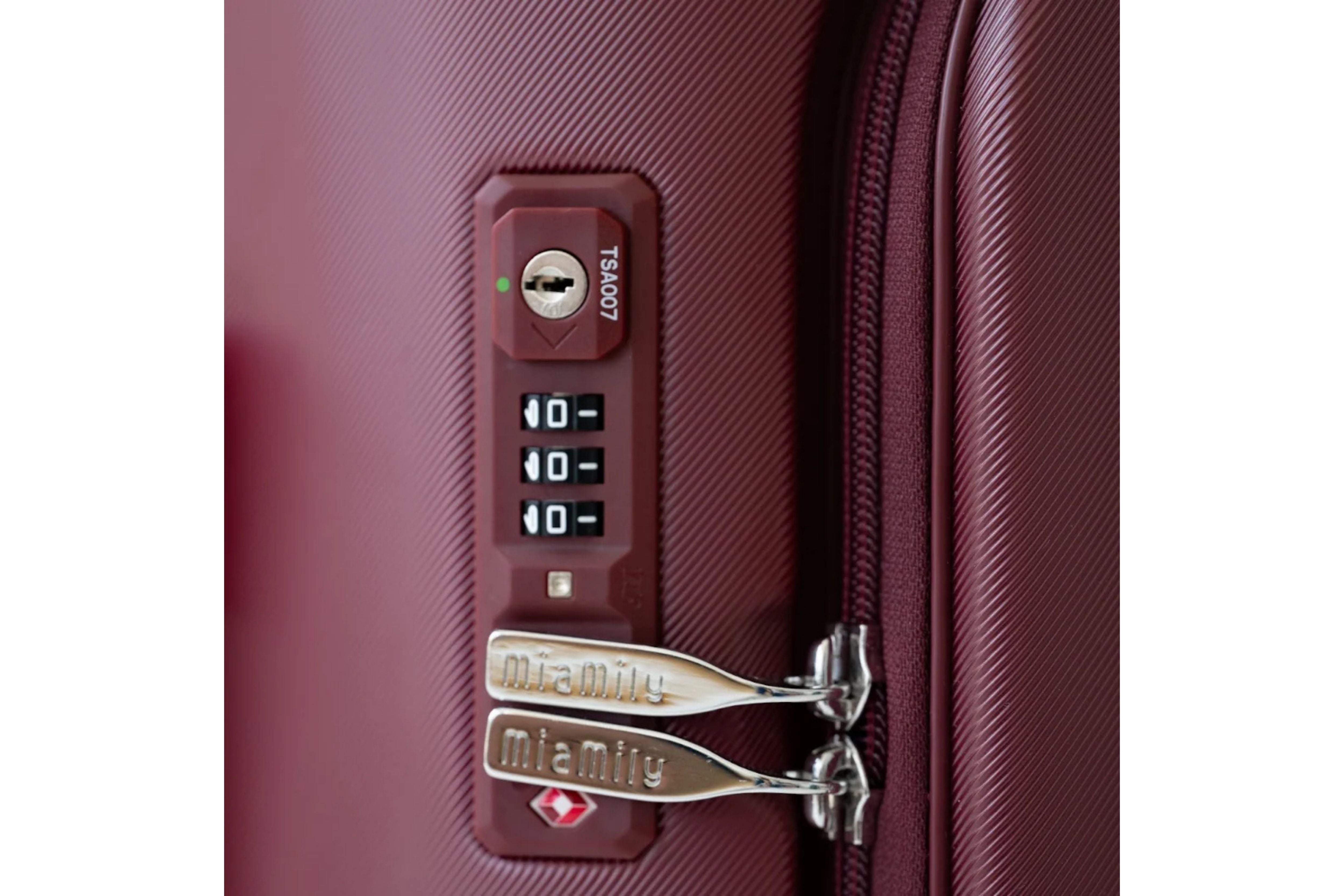 Close up of the TSA-approved 3 digit zipper lock on the side of the MiaMily Carry On Plus 18” Luggage