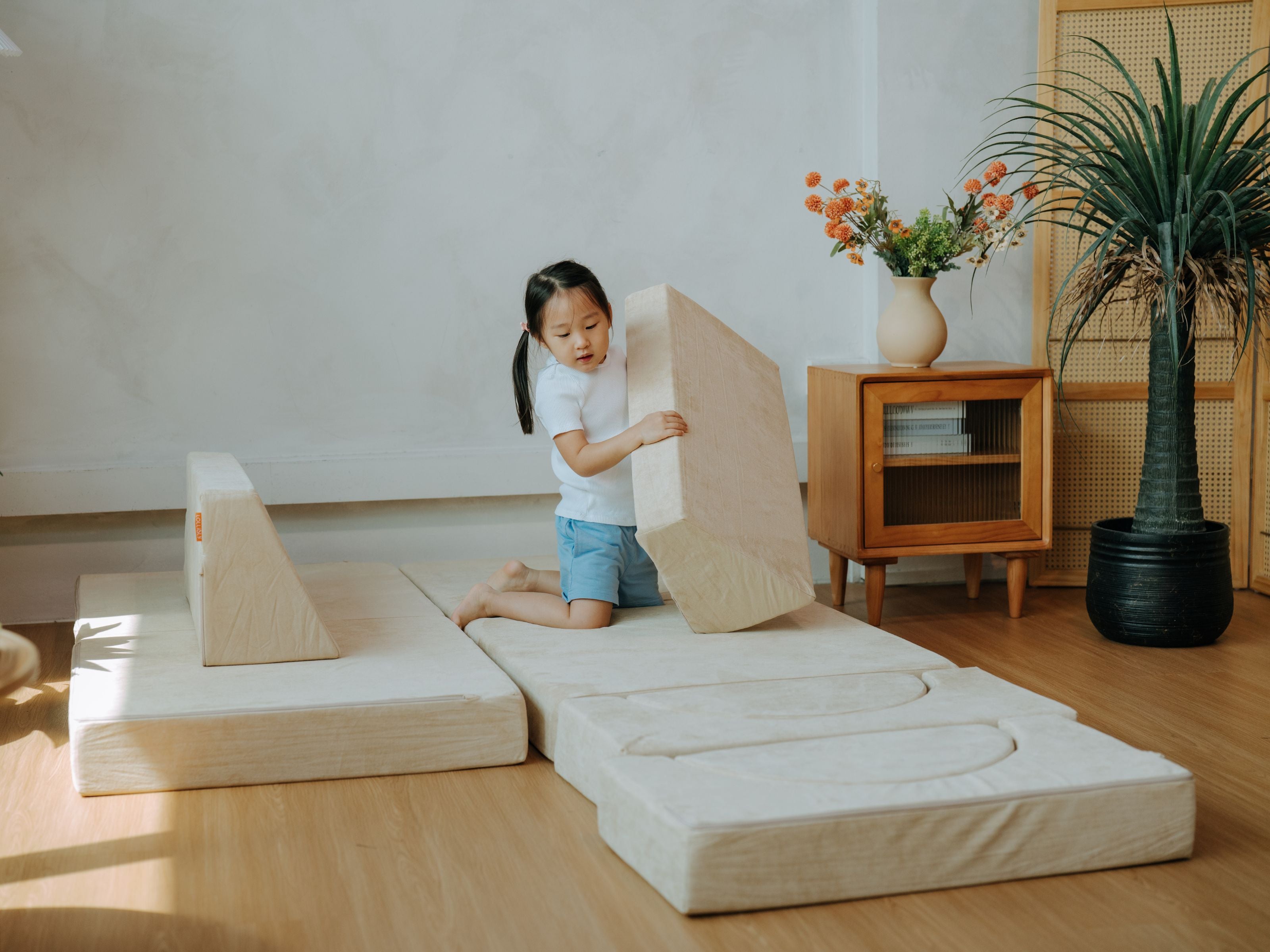 Child stacking and assembling pieces from the Lollibly Wonderstack Play Sofa