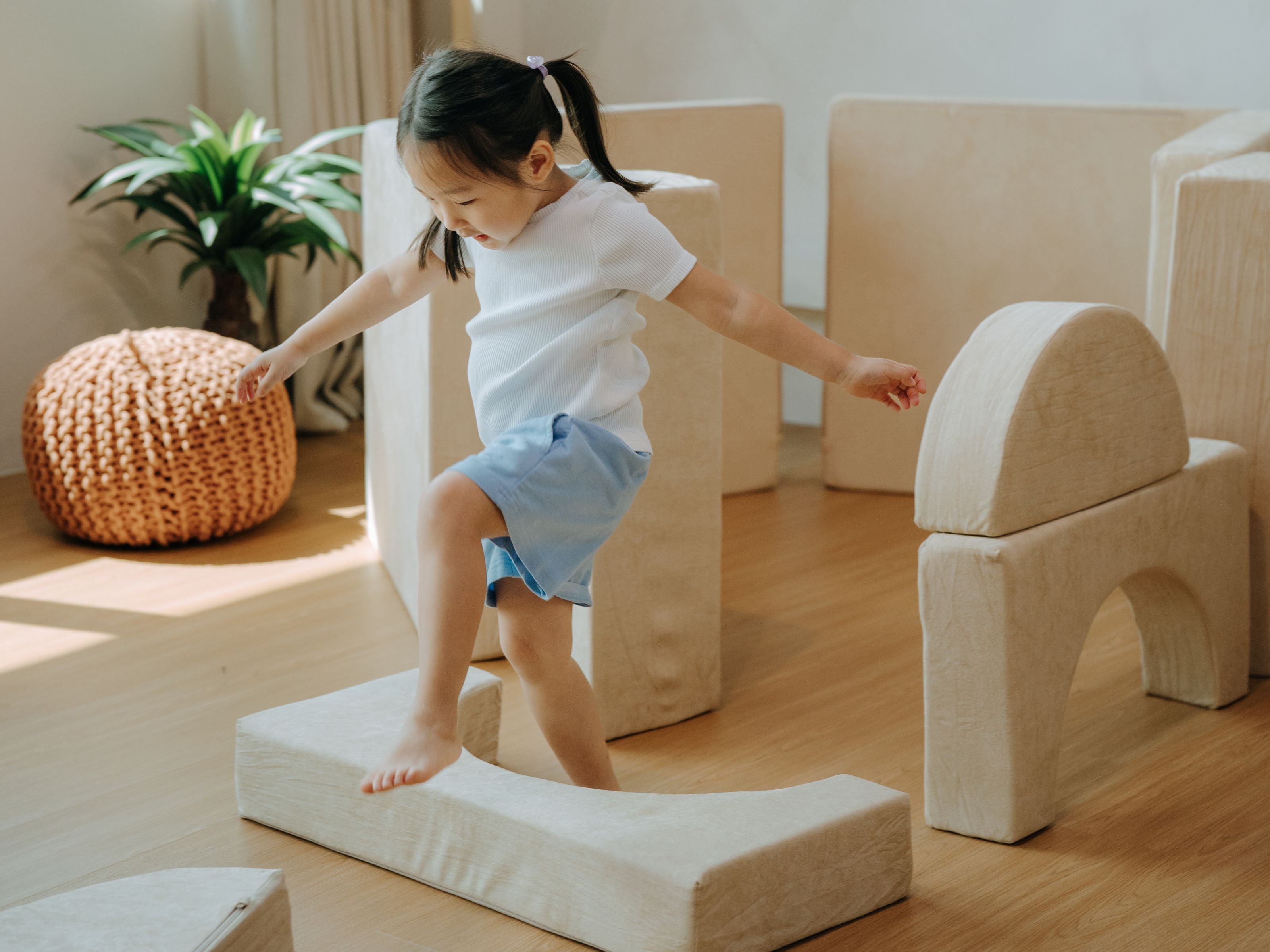 Child jumping over some pieces from the Lollibly Wonderstack Play Sofa