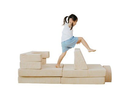 Child jumping over the pieces of the Lollibly Wonderstack Play Sofa