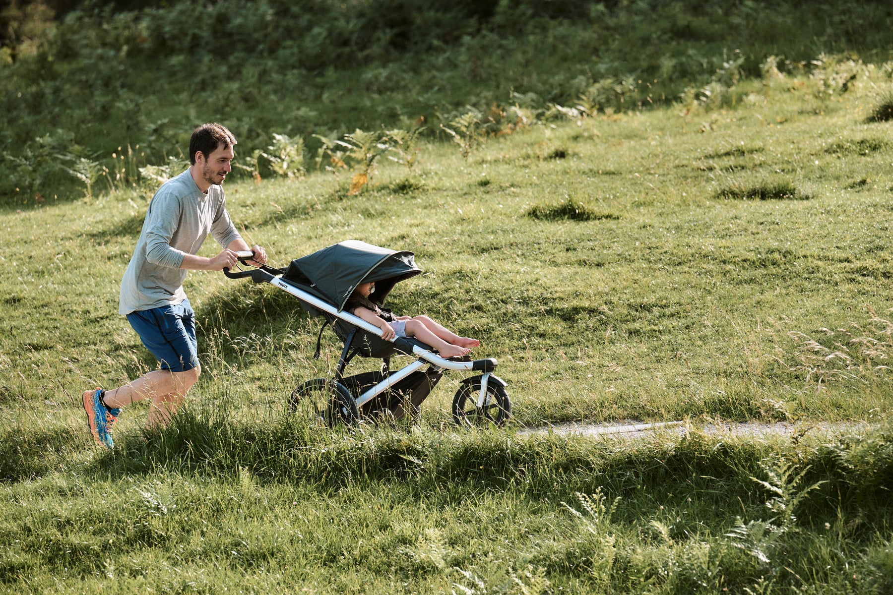 Dad running with child in jogging stroller