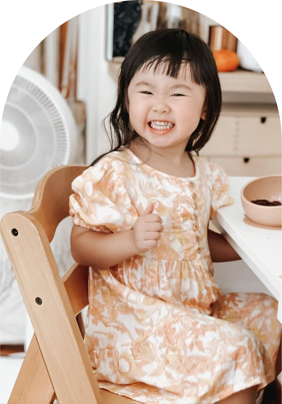girl sitting on alpha high chair enjoying lunch at the dining table