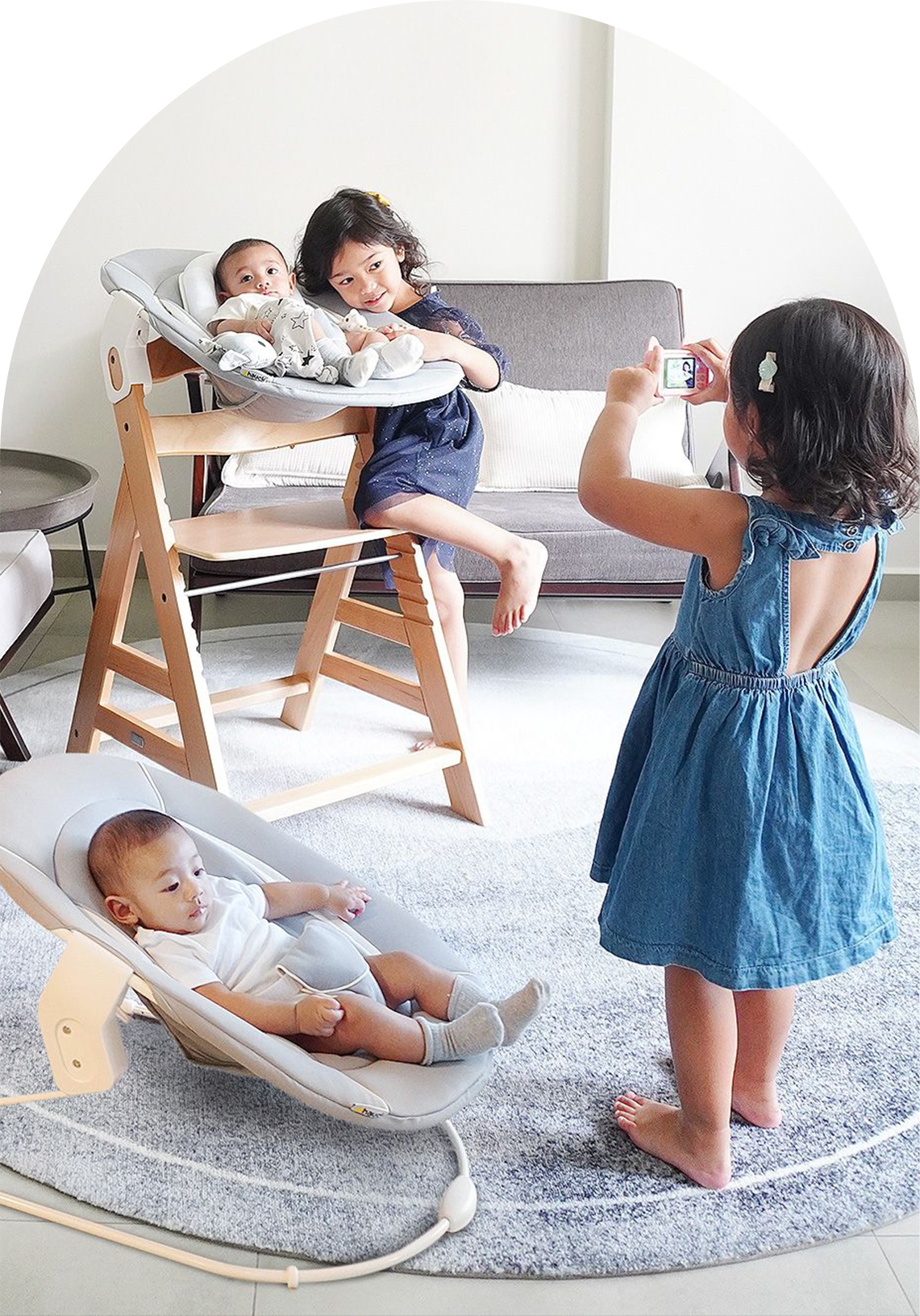 girl taking photo of sister and brother on alpha high chair with removable 2 in 1 bouncer attachment