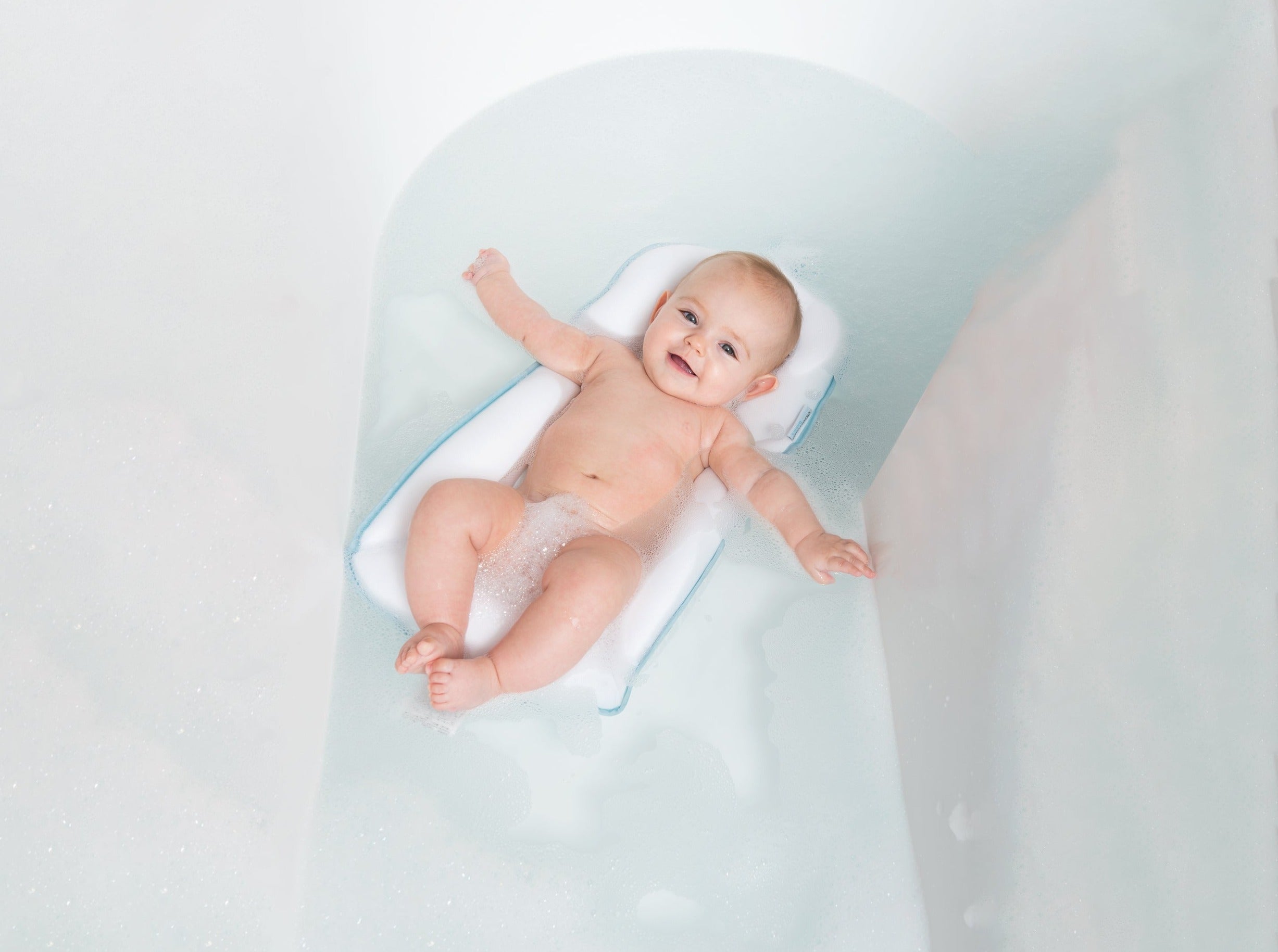 baby in bath tub on easy bath cushion