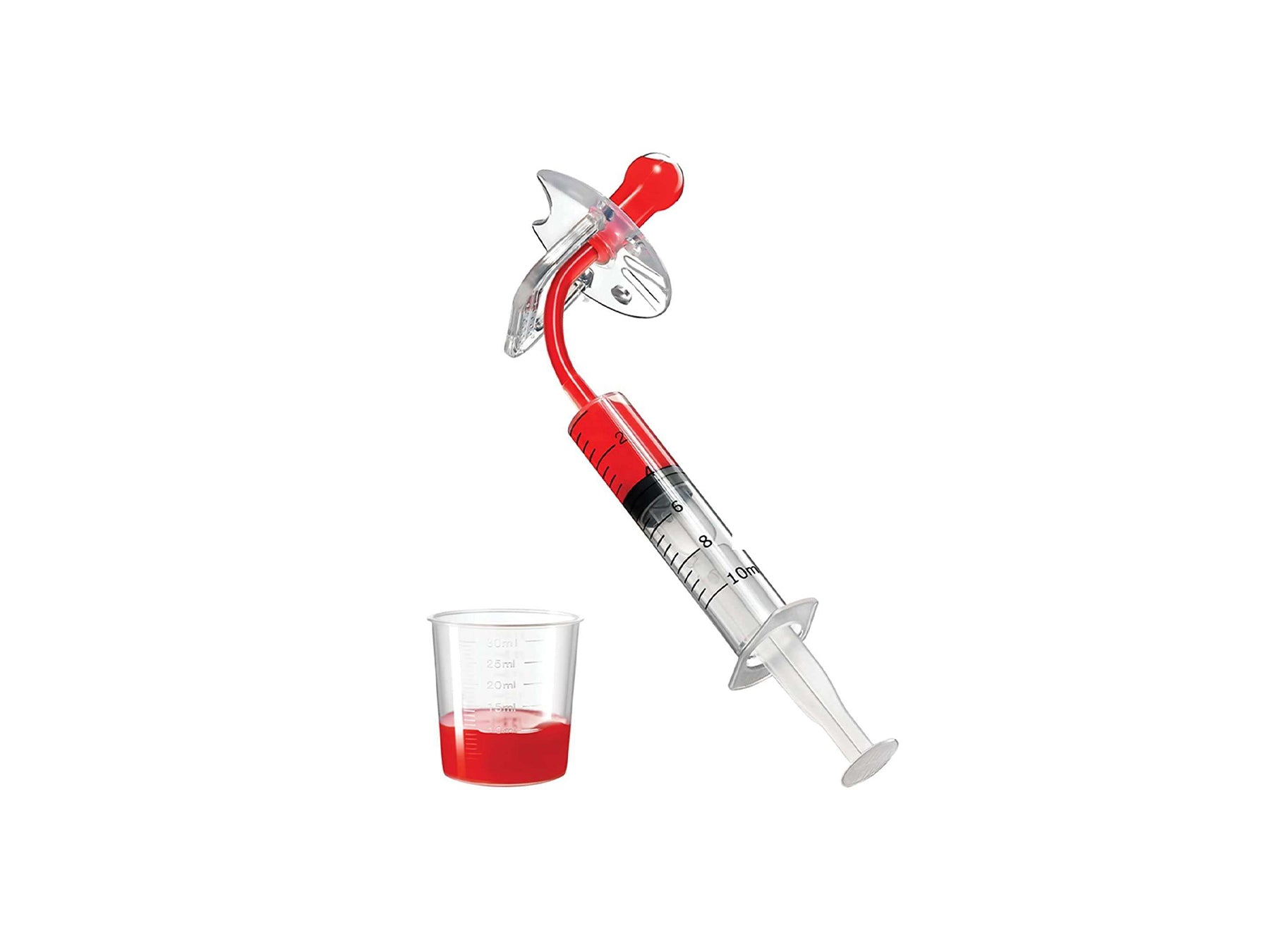 dose pacifier with syringe and cup of baby liquid medicine