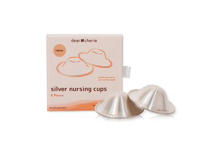 Silver nursing cups with packaging labeled 'dear cherie' on a white background