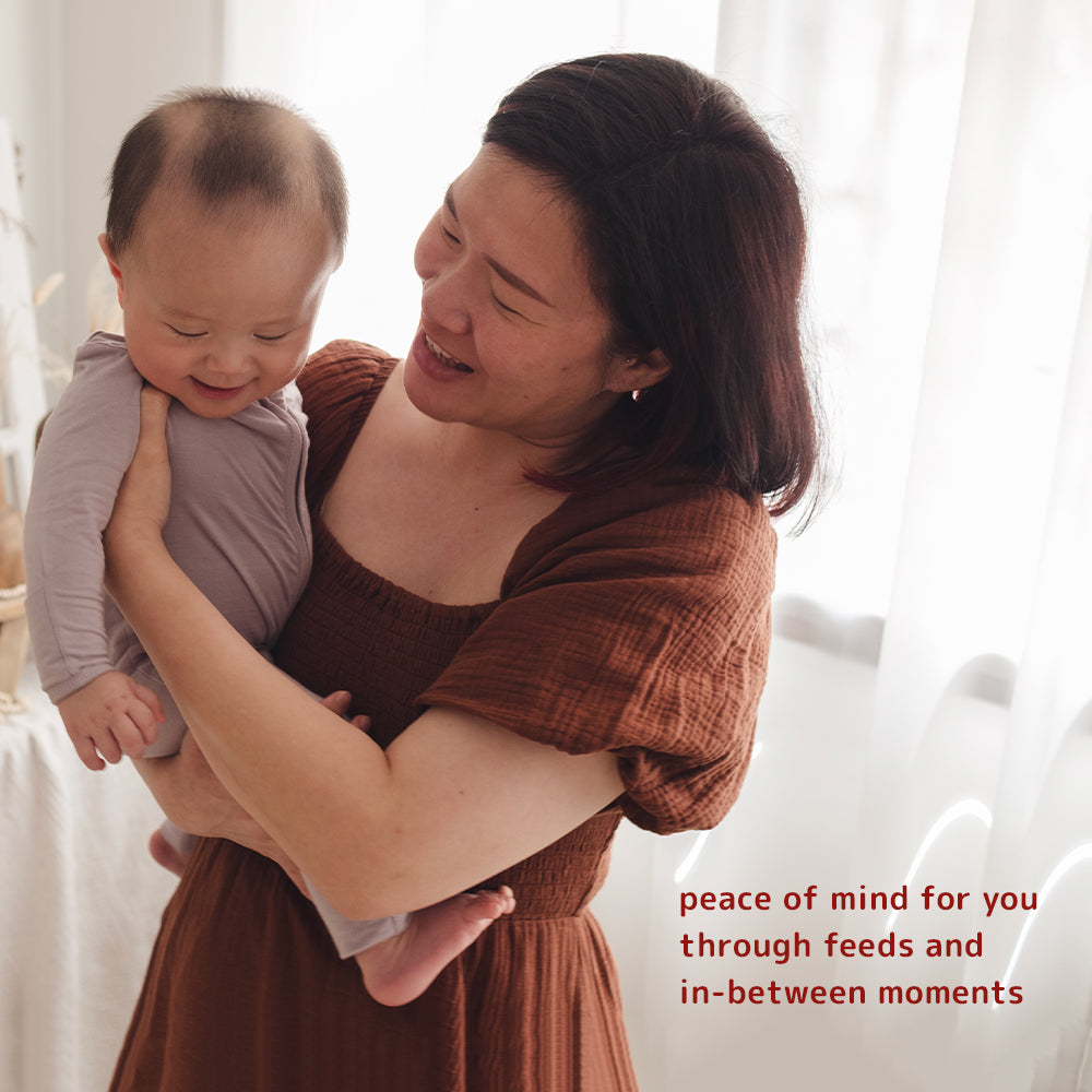 Woman holding a baby with supportive text about Dear Cherie disposable nursing breast pads giving mums a peace of mind during feeds and in-between moments