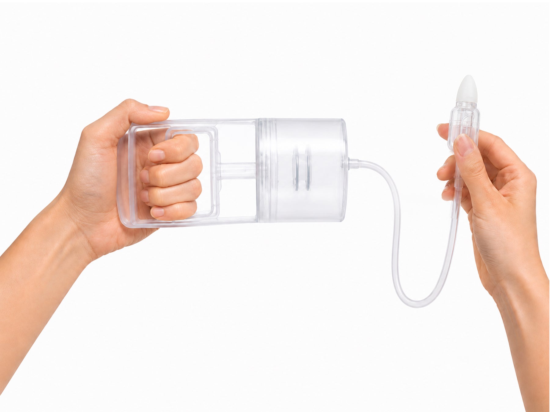 A pair of hands demonstrating the Dear Cherie Hand Pump Nasal Aspirator.