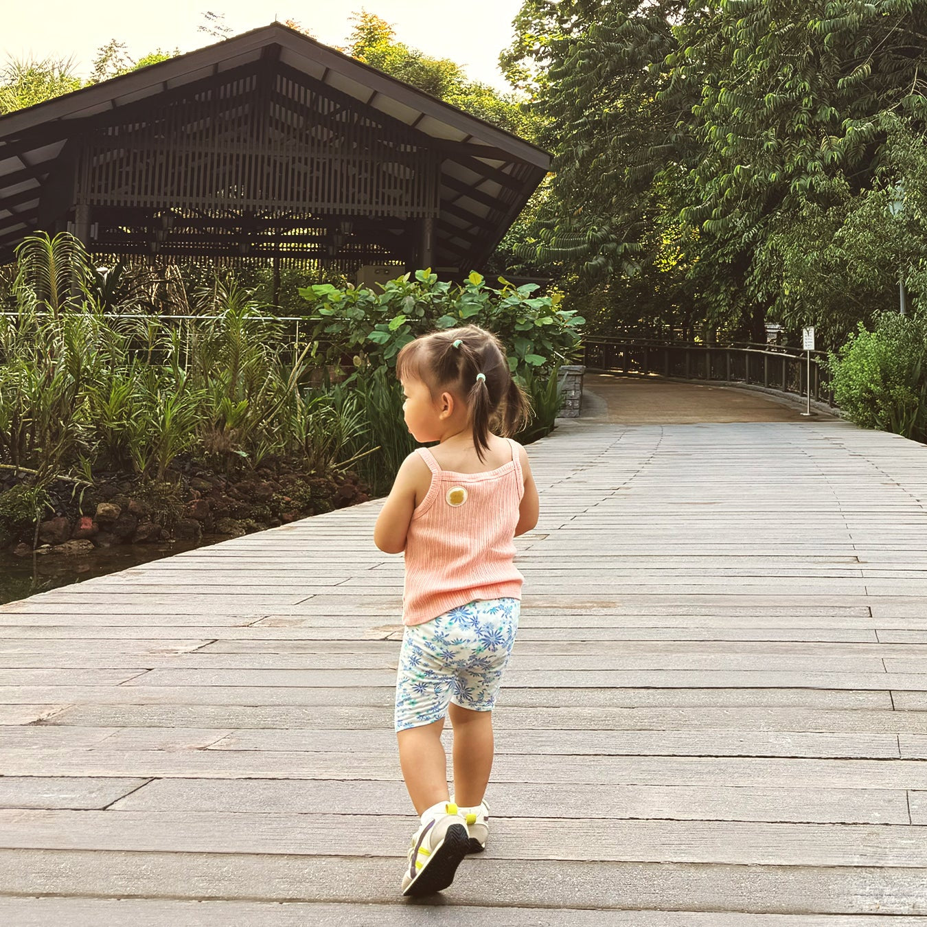 child walking beside pond with mosquito repellent patch on shirt