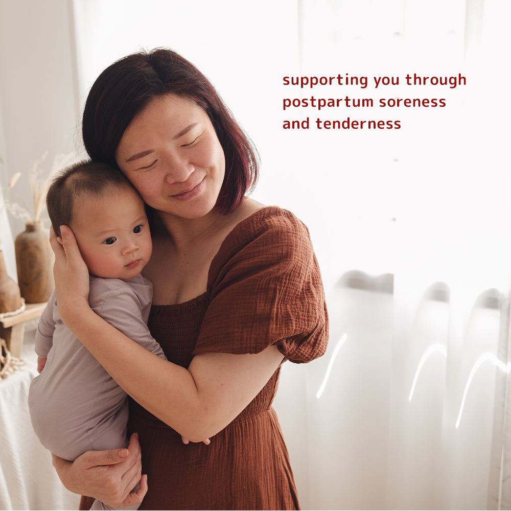 Woman holding a baby, with supportive text graphic about Dear Cherie peri bottle providing support for postpartum soreness and tenderness