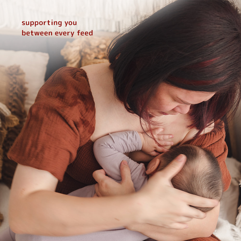 Woman holding a baby with supportive text about Dear Cherie silver nursing cups, offering care between every feed