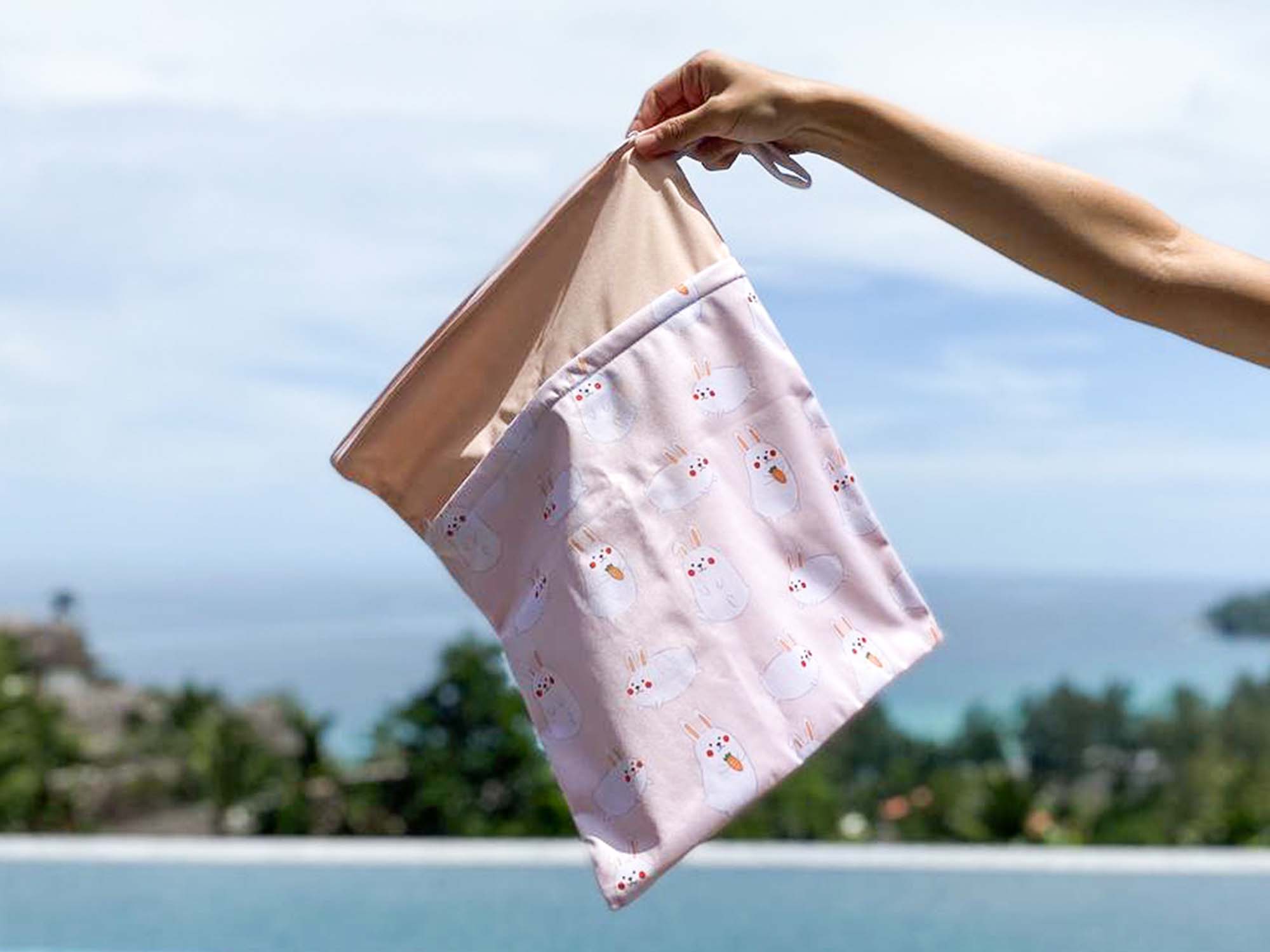 momo bunny wet bag against sea background