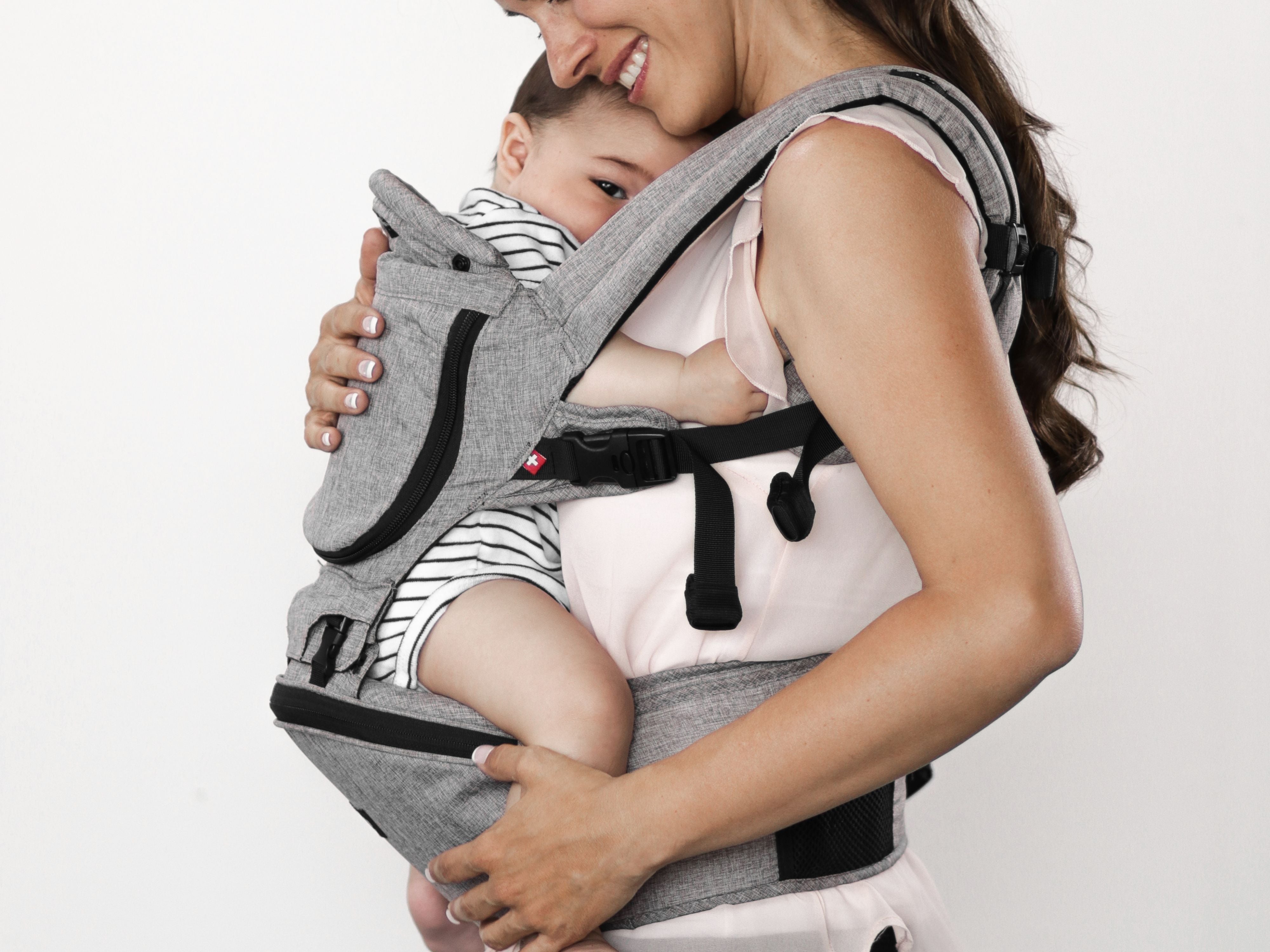 baby lying on mom chest in hipster plus carrier#color_stone-grey