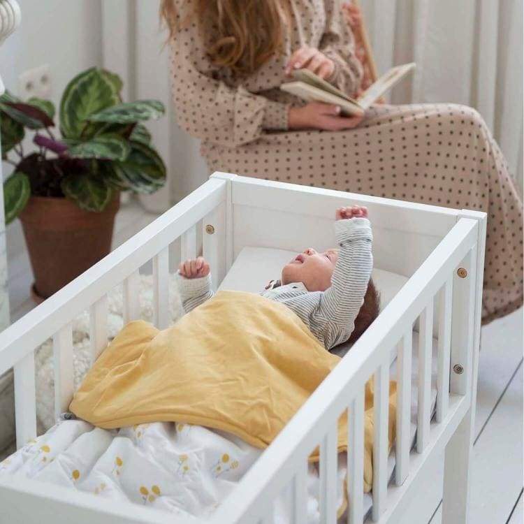 baby in crib with doomoo dream lollypop ocre blanket#color_lollypop-ocre