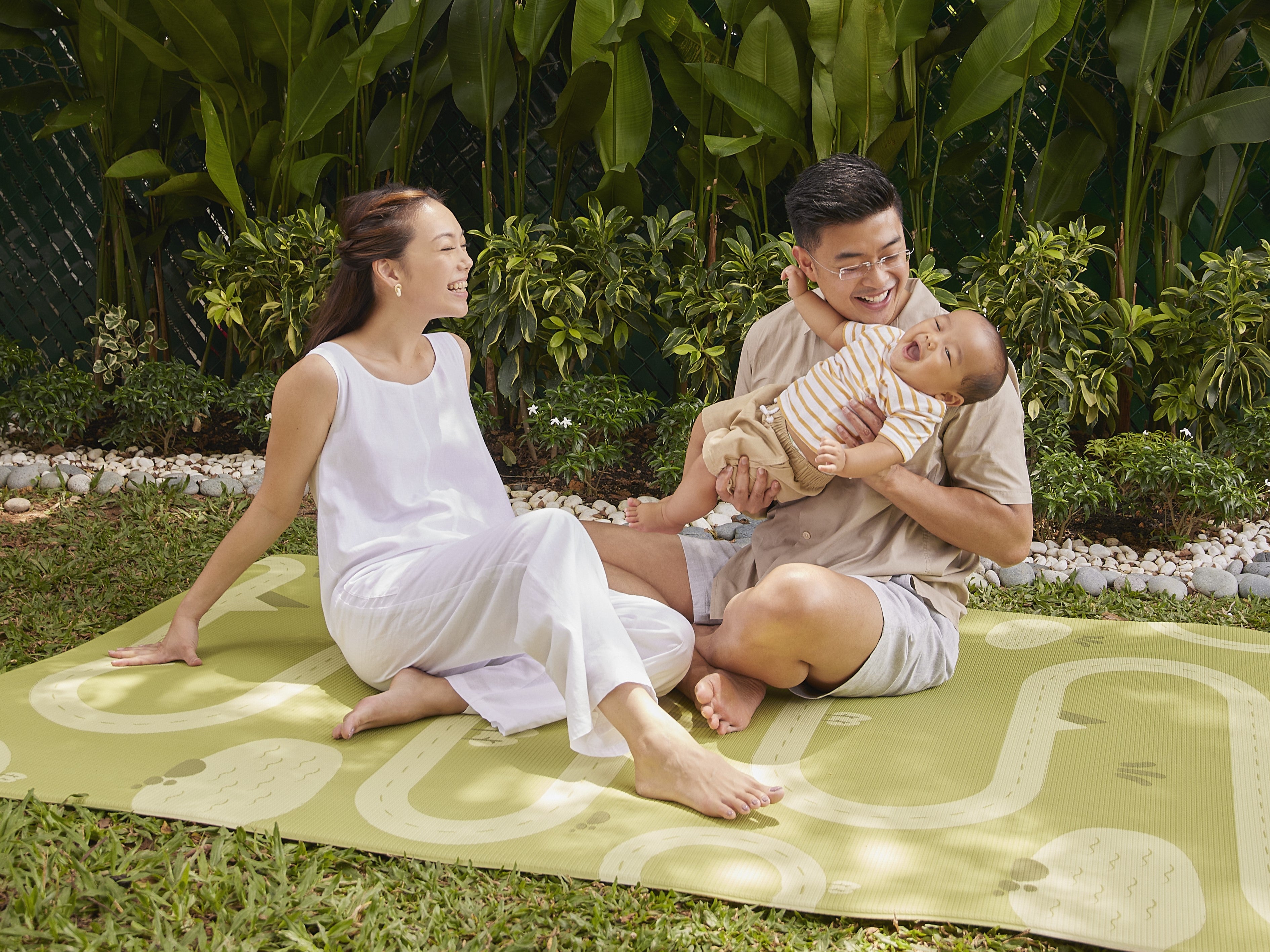 parents playing with baby boy on lollibly habitat play mat