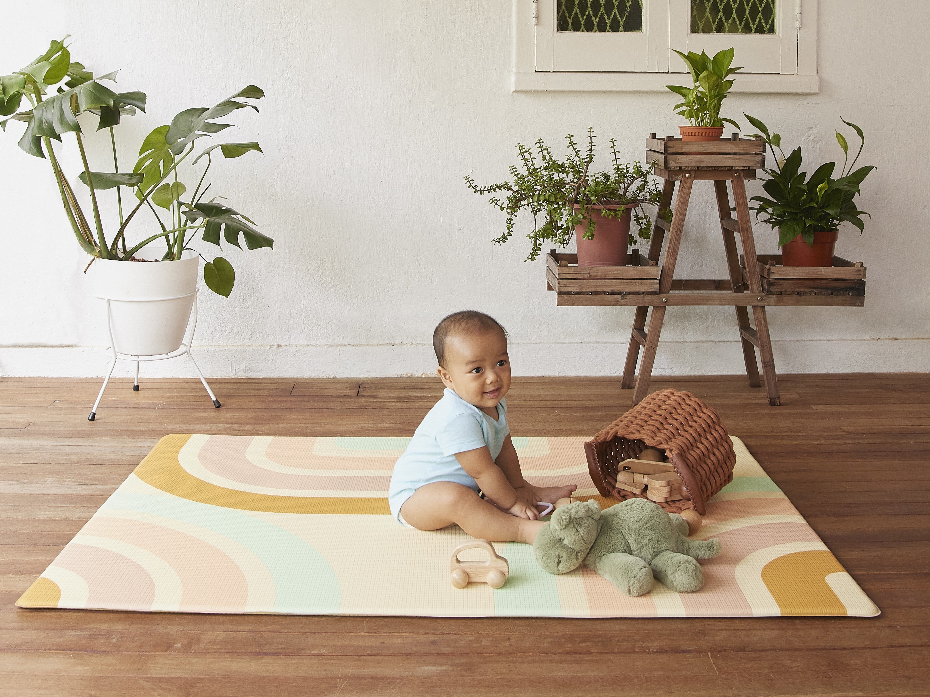 baby with toys on lollibly holiday play mat