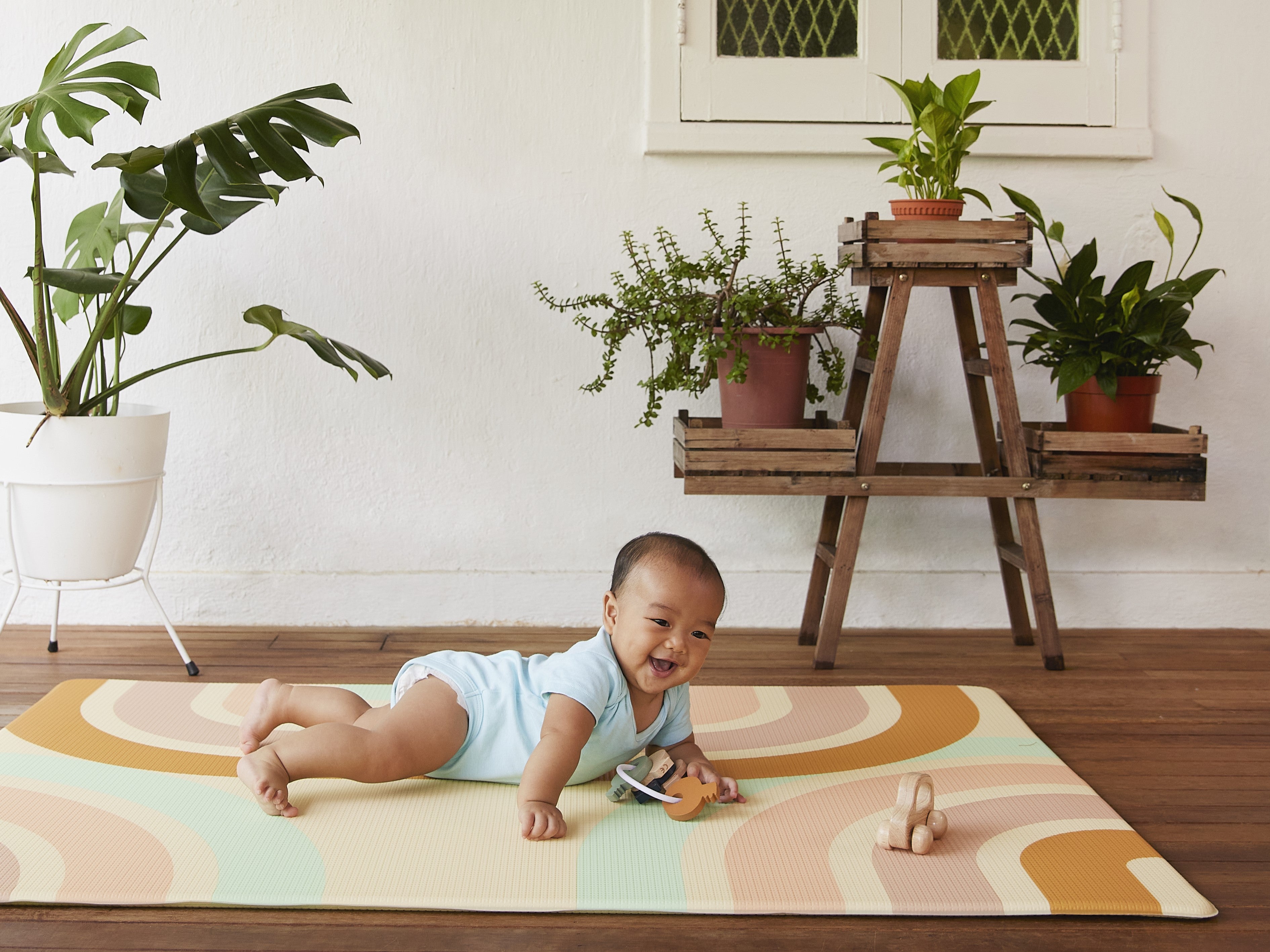 boy playing happily on lollibly holiday play mat