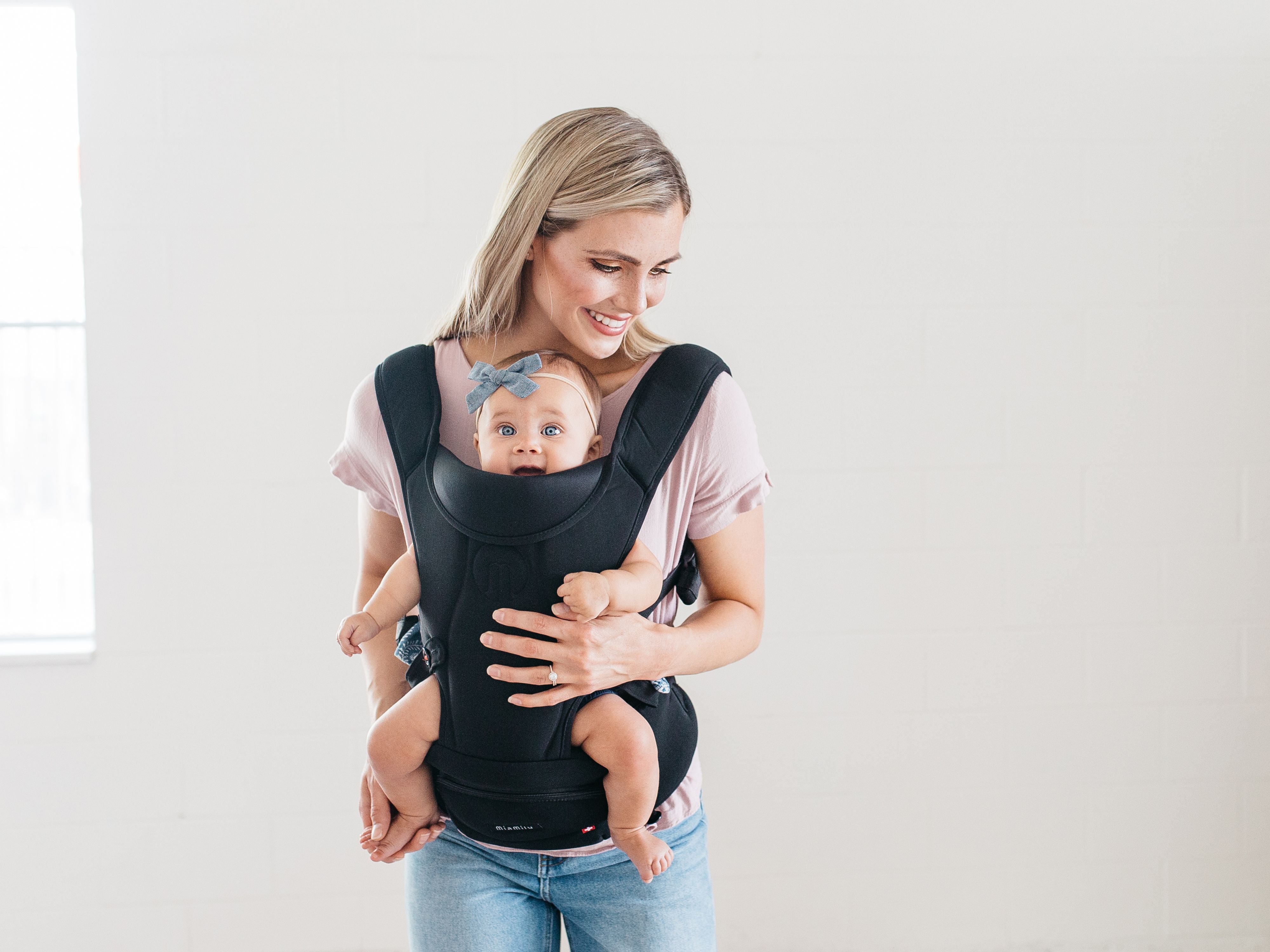 mom front carry happy baby in miamily hipster essential