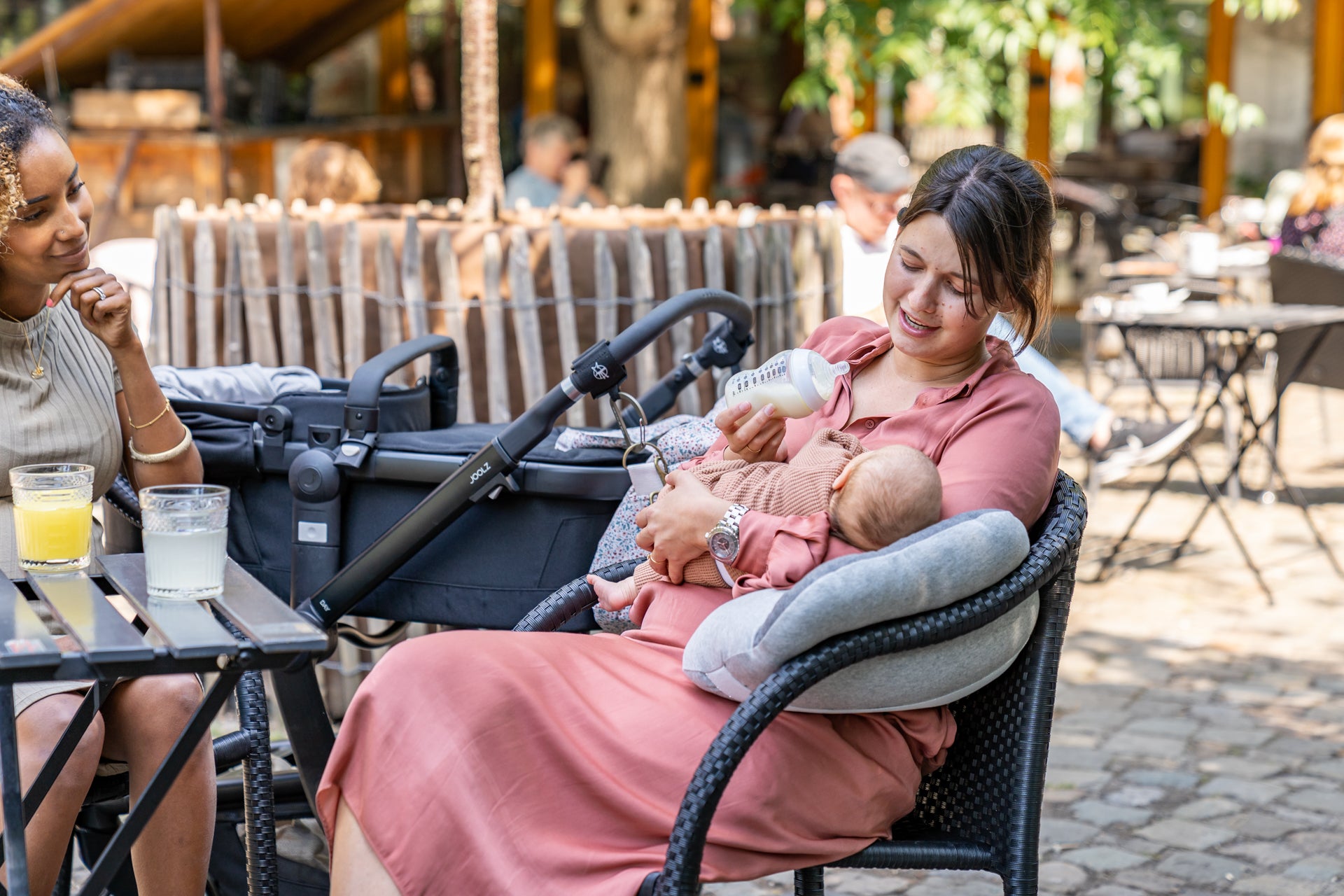 mom using on the go pillow as nursing pillow while feeding baby